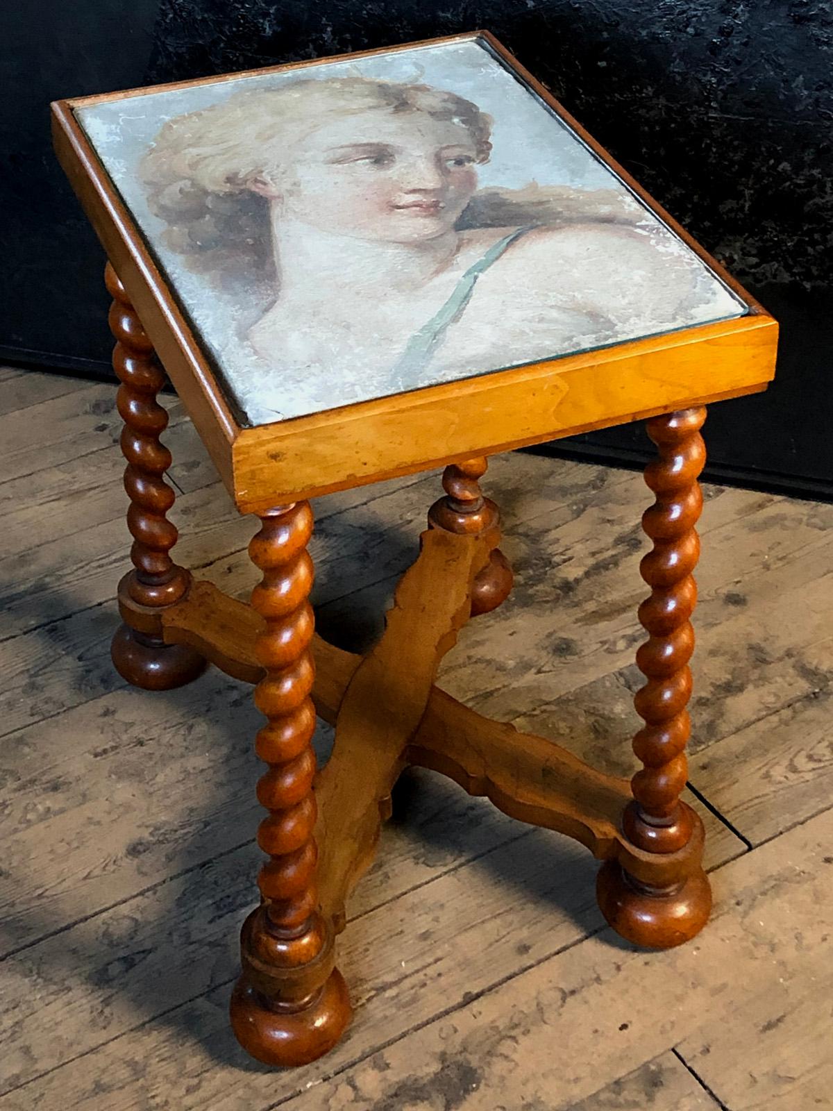 Small occasional table, the top inset with a 17th century Fresco-Fragment featuring a sensuous portrait of the Hunting Goddess Diana, attributed to a Follower of Annibale Carracci. 
The walnut and fruit wood table of early 20th century manufacture,