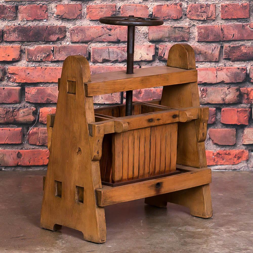 A fun find, this antique Hungarian wine press was hand made from solid hard wood circa 1900 and built to last. Everything appears to be original from the cast iron screw which turns easily, to the rectangular pressure plate and the staved cage. Note