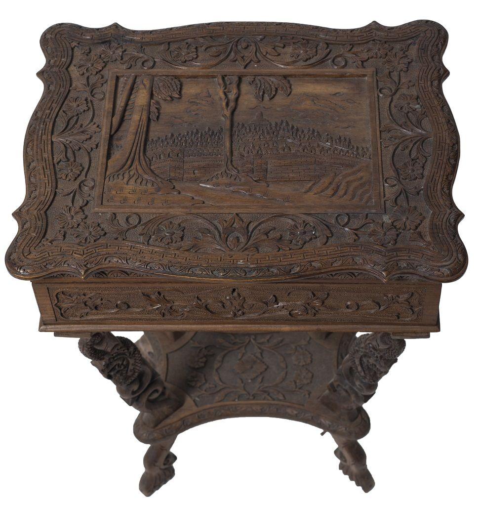 Small table is an original wood design furniture realized during the 20th century.

This little wood table entirely carved with flowers and plant elements, dragons, and landscape with architecture.

Extendable top with open compartments inside.