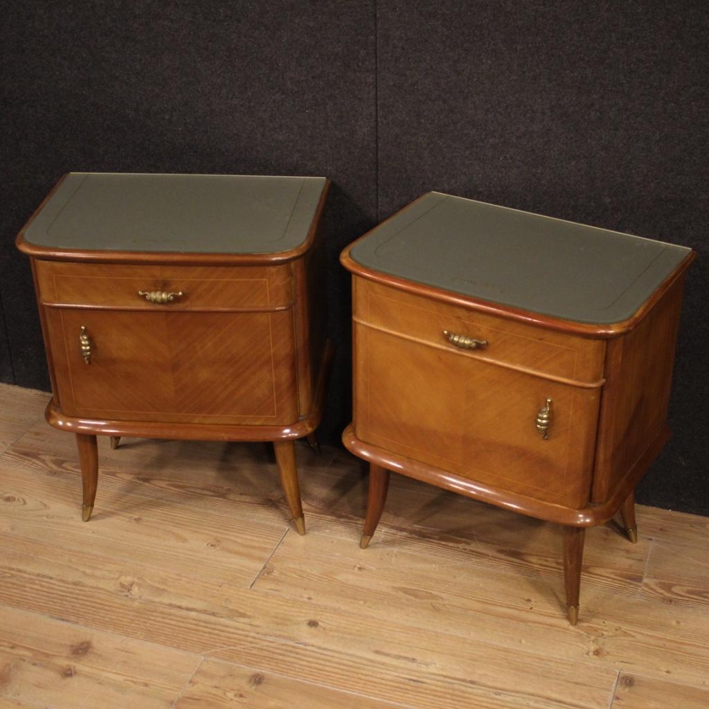Couple bedside tables of Italian design of the 1950s-1960s. Furniture of beautiful line and pleasant furnishings in walnut, maple and Beech tree with brass decorations gold. Bedside tables supported by solid wooden legs solid wood with brass feet