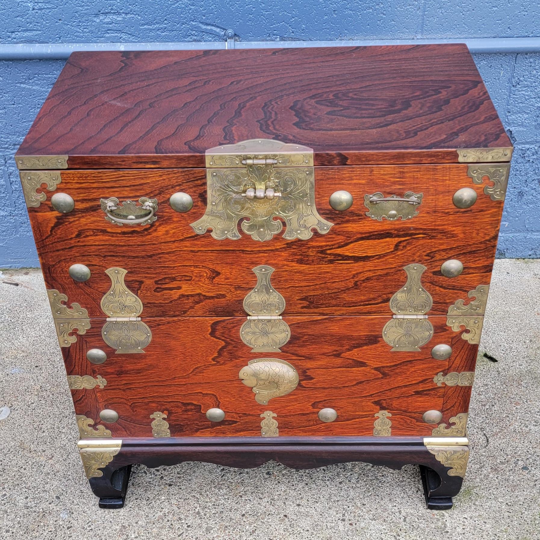 Small Tansu cabinet with brass mounts. Beautiful wood grain. I believe this to be Korean and from the mid to late 20th century.