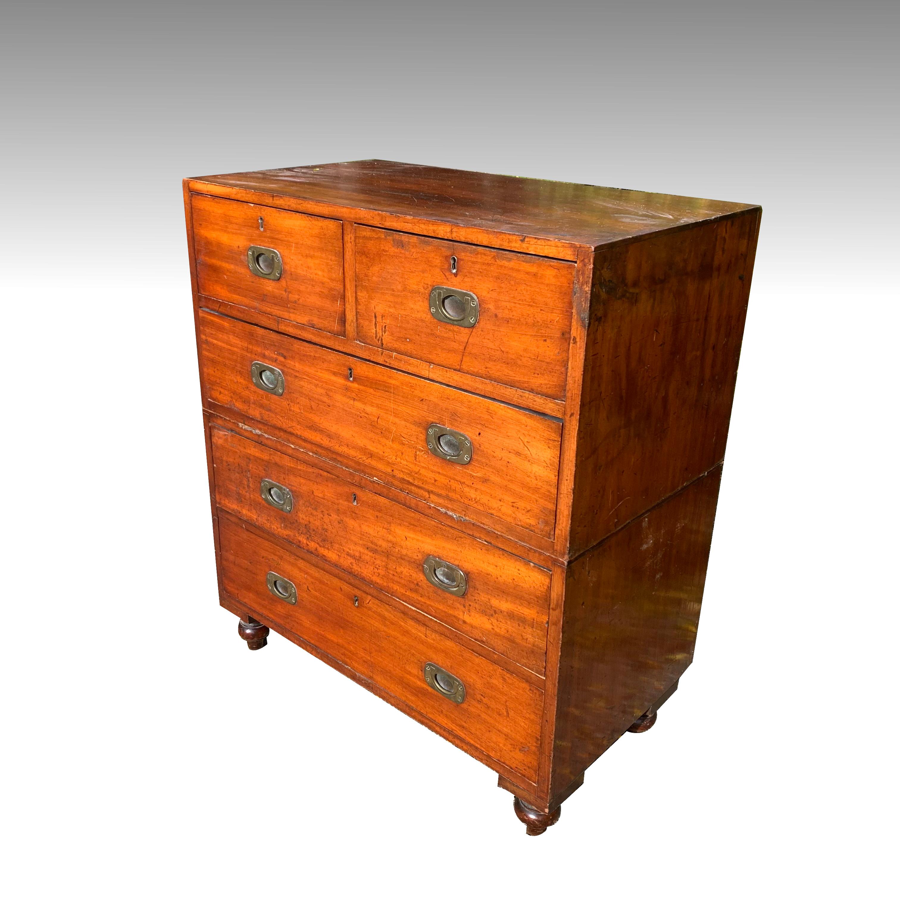 A fine example of an early 19th century teak military or campaigne chest of drawers. Smaller than average at just 34 inches wide, in two parts.
This fine piece is in excellent, original 'Country House condition' with the odd scuff, bruise, dent and