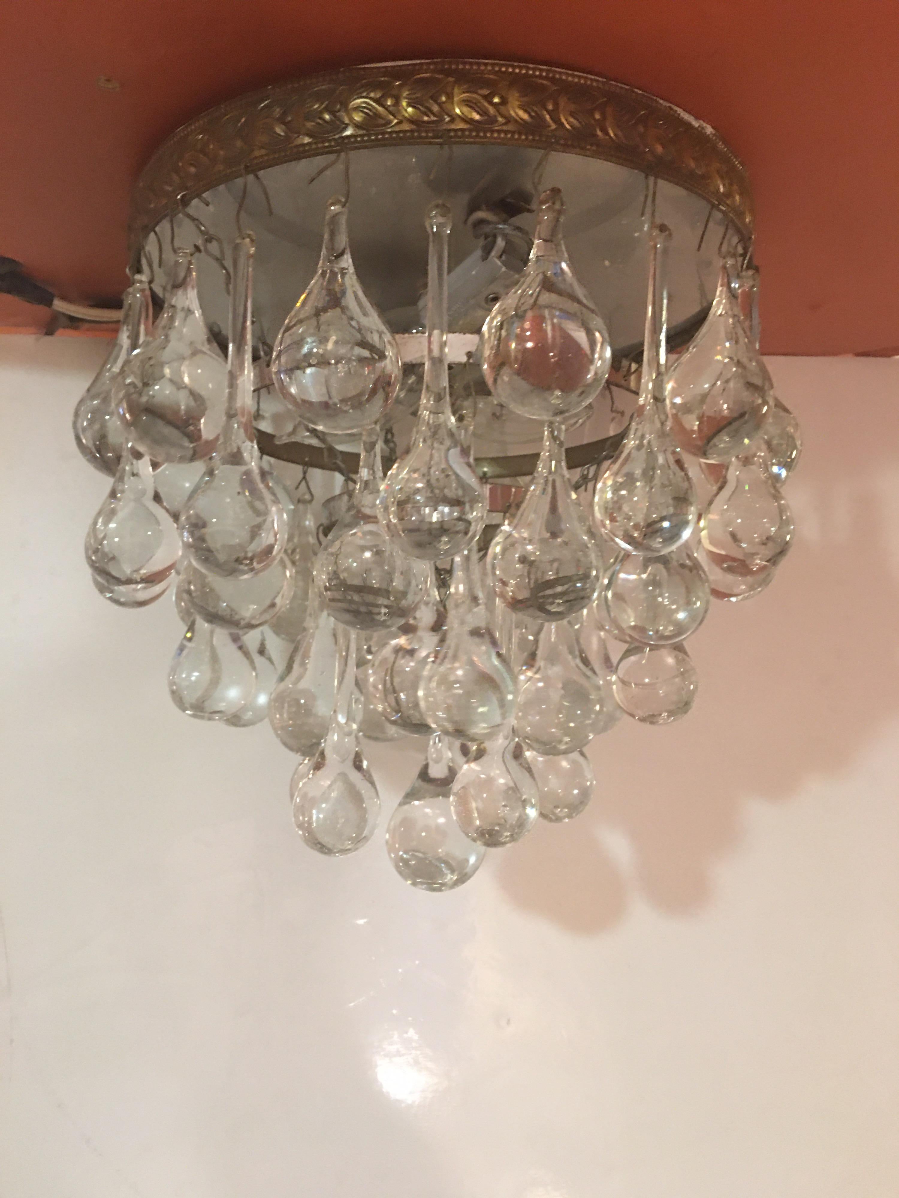 Tear drop ceiling fixture, 2 available! Flush mounted, perfect for an entrance or hallway. Brass trim around top. Alternating tear-drop crystals in 2 sizes.