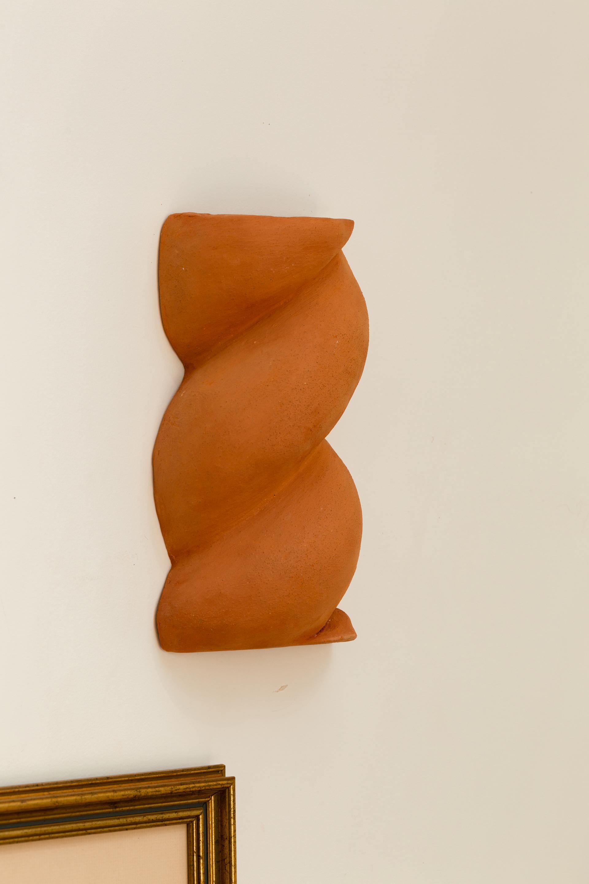 Small Terracotta Babka Sconce by Di Fretto
Dimensions: W 15 x D 10 x H 28 cm
Materials: Terracotta Faience (not glazed)
Also Available: White (not glazed)


The Babka wall light is a twist of chamotte terracotta earthenware. It is a symbol of