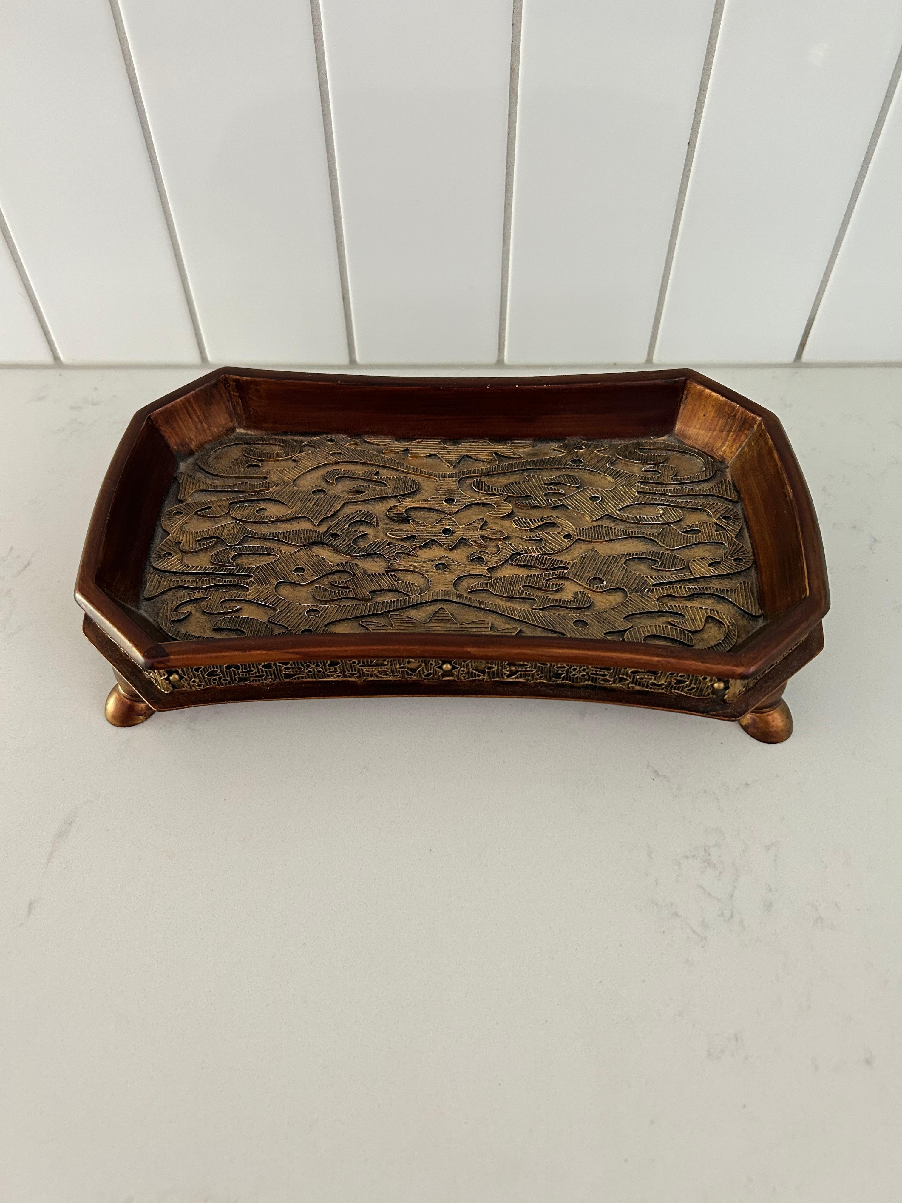 Art Nouveau style small tray on four little circular legs, perfect for a nightstand jewelry holder.  High quality and durable tooled brass construction.

Intricate Art Nouveau French design in the middle of the tray and around the exterior border. 