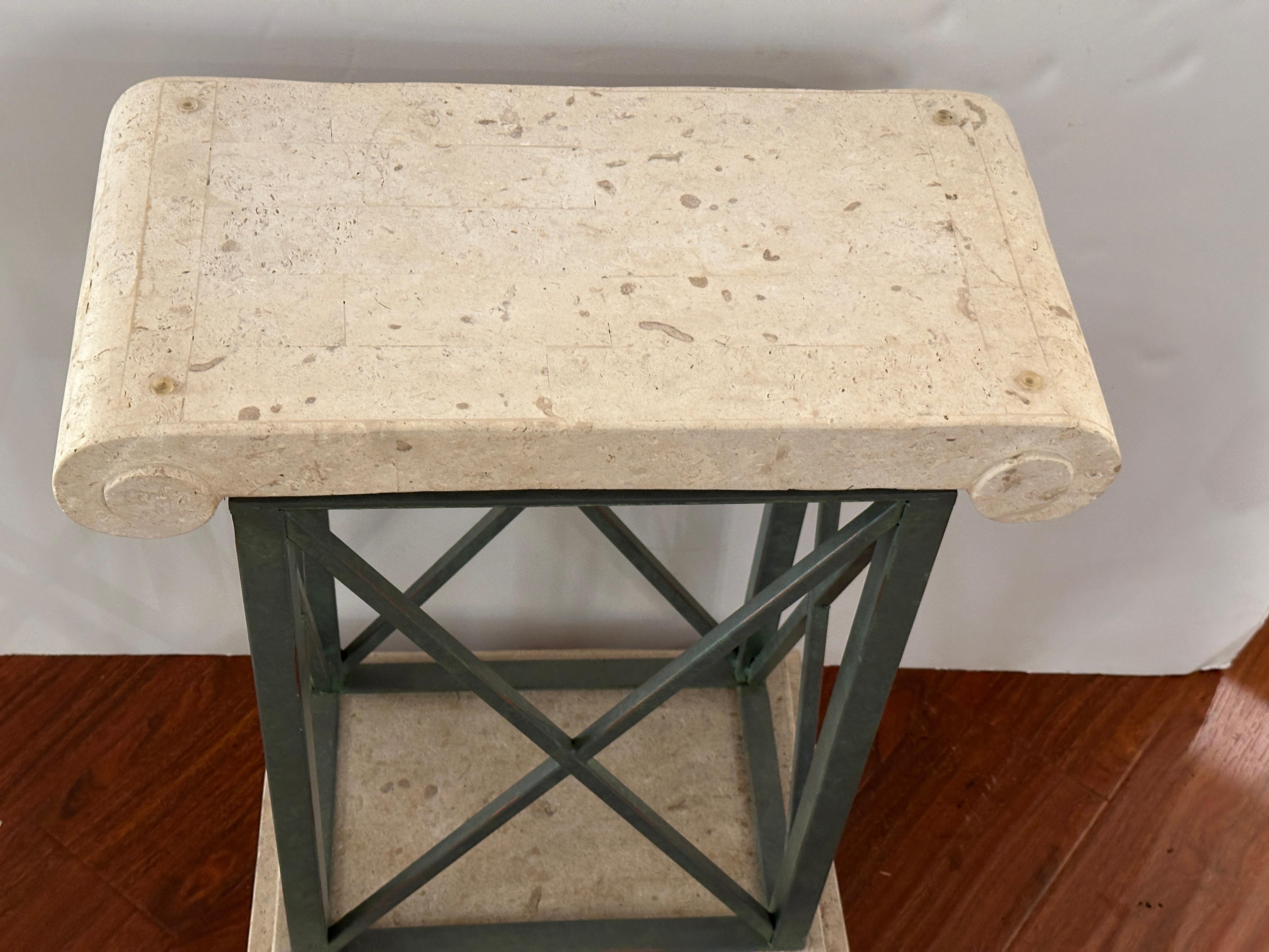This little Console features a travertine top and an X-shaped green-painted base. The top's smooth surface is adorned with curved edges reminiscent of the Greek influences found during the Hollywood Regency period.


