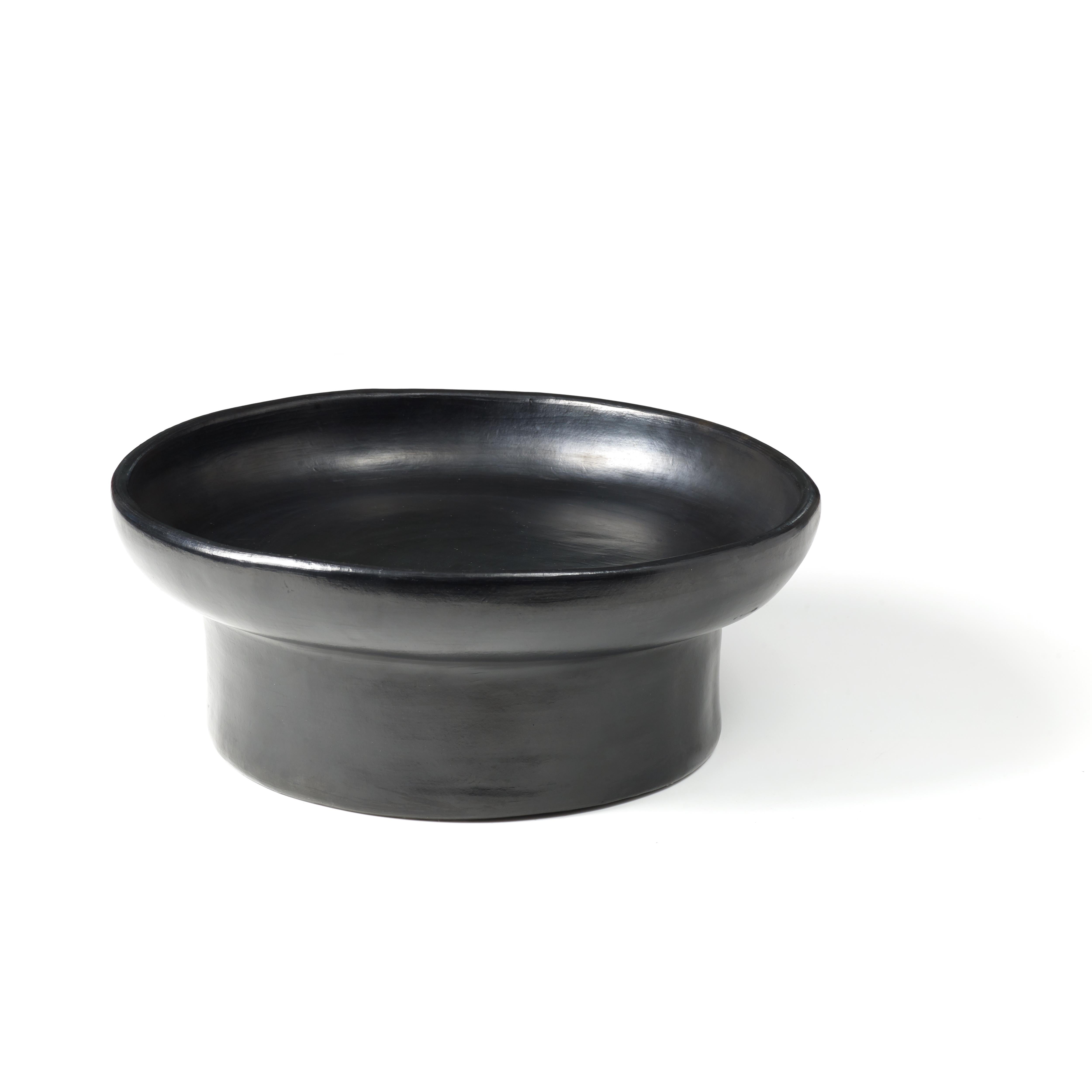 Small tray 2 by Sebastian Herkner
Materials: Heat-resistant black ceramic. 
Technique: Glazed. Oven cooked and polished with semi-precious stones. 
Dimensions: Diameter 32 cm x height 10 cm 
Available in sizes large and mini. 

This pot