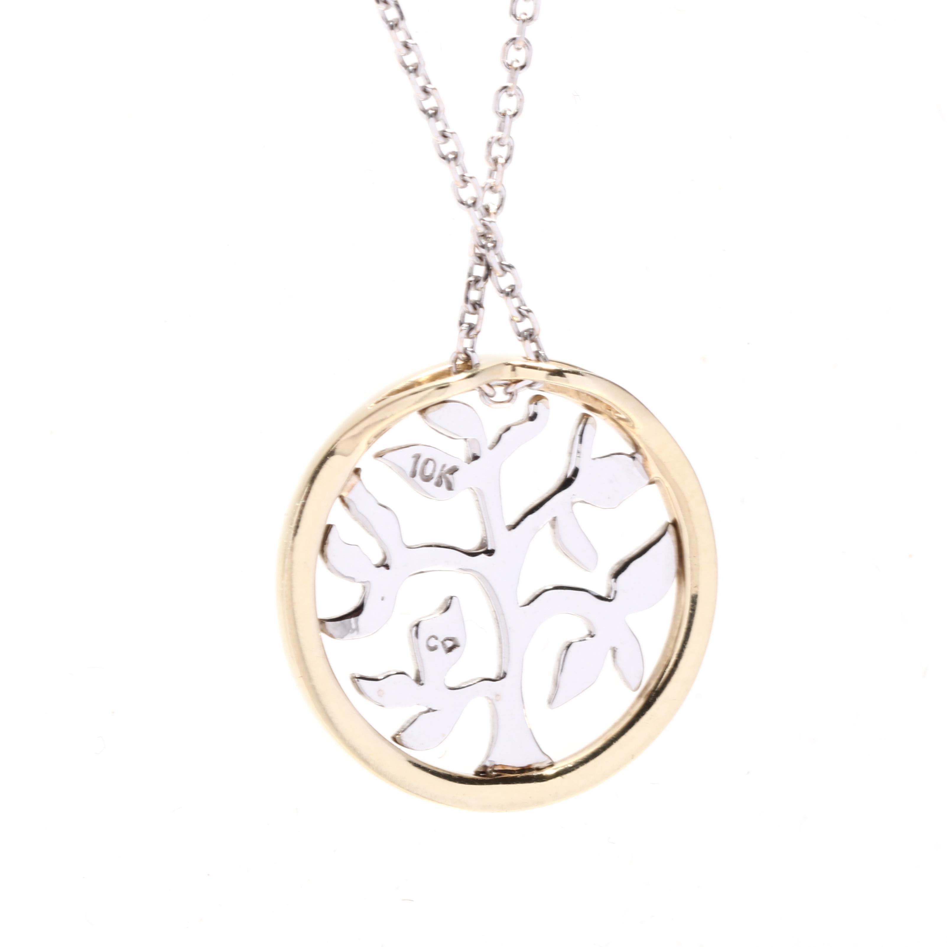 A vintage 10 karat yellow and white gold small tree of life pendant necklace. This simple round pendant features a white gold tree of life design cut out in with a yellow gold bezel and suspended from a thin cable chain.

Chain Length: 18 in.

Chain