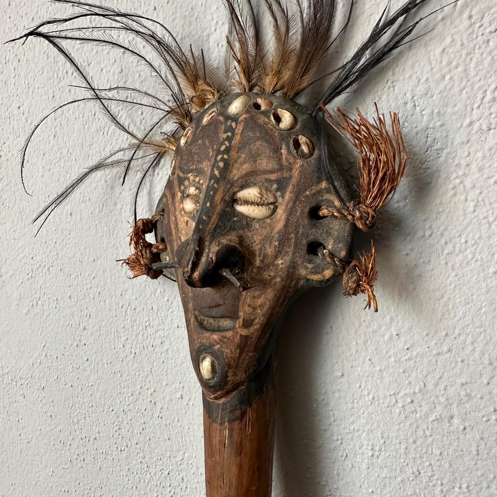 Add a touch of culture with this striking small tribal mask. Its intricate design makes it a captivating decorative piece for any wall.