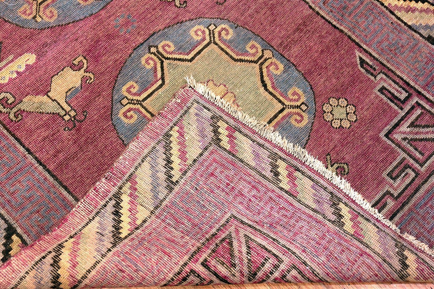 An extremely artistic small size Tribal purple antique Khotan rug, country of origin / Rug type: Antique East Turkestan rugs, circa date: 1900. Size: 4 ft x 8 ft (1.22 m x 2.44 m)

For centuries, antique Khotan rugs have stood out for their unique