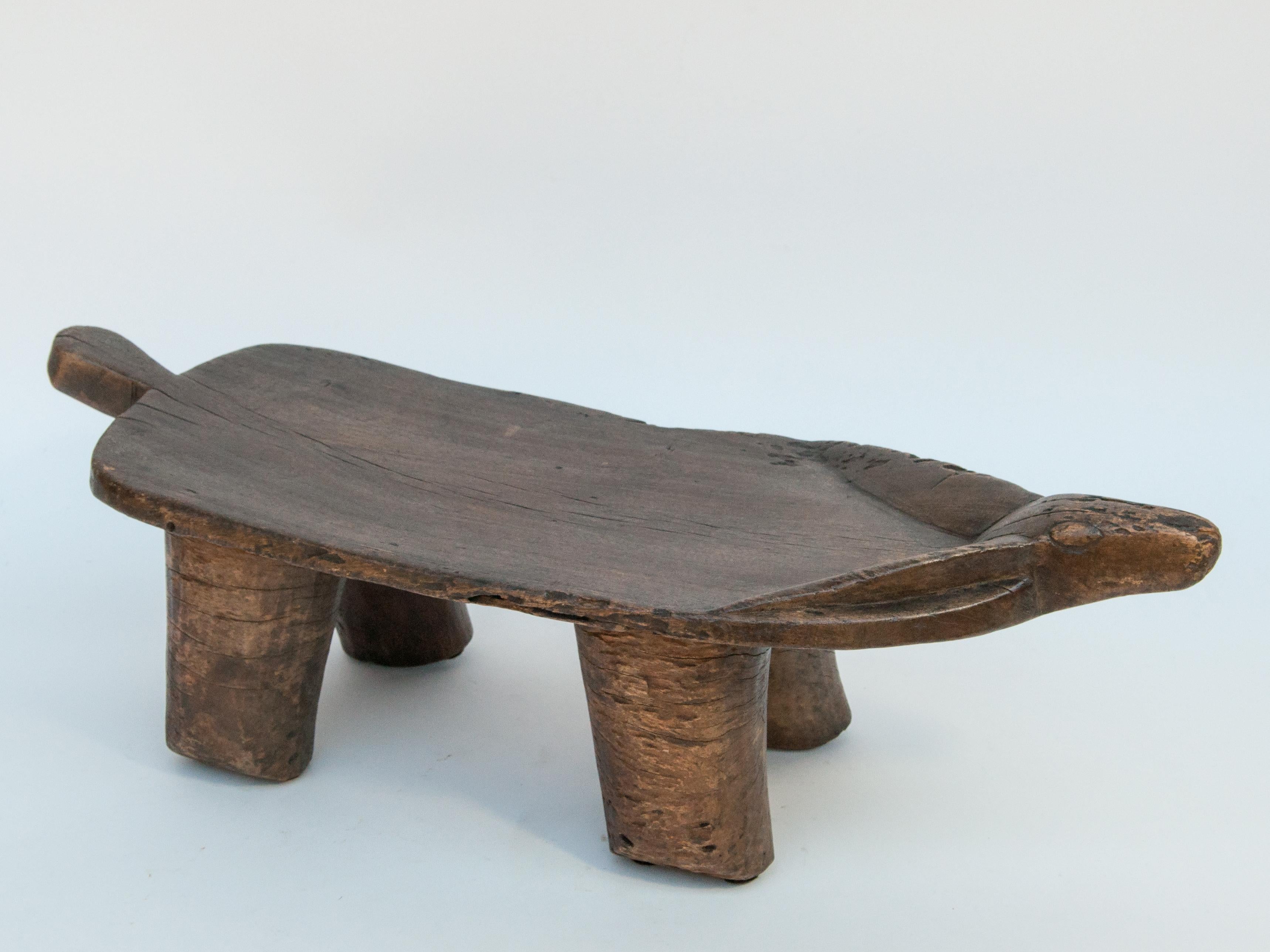 Small tribal wooden stool, animal motif. Fulani people of Niger, Mid-late 20th century.
Offered by Bruce Hughes.
This playful rustic wooden stool was fashioned by hand from a single piece of wood. Using very basic tools. It comes from the Fulani,