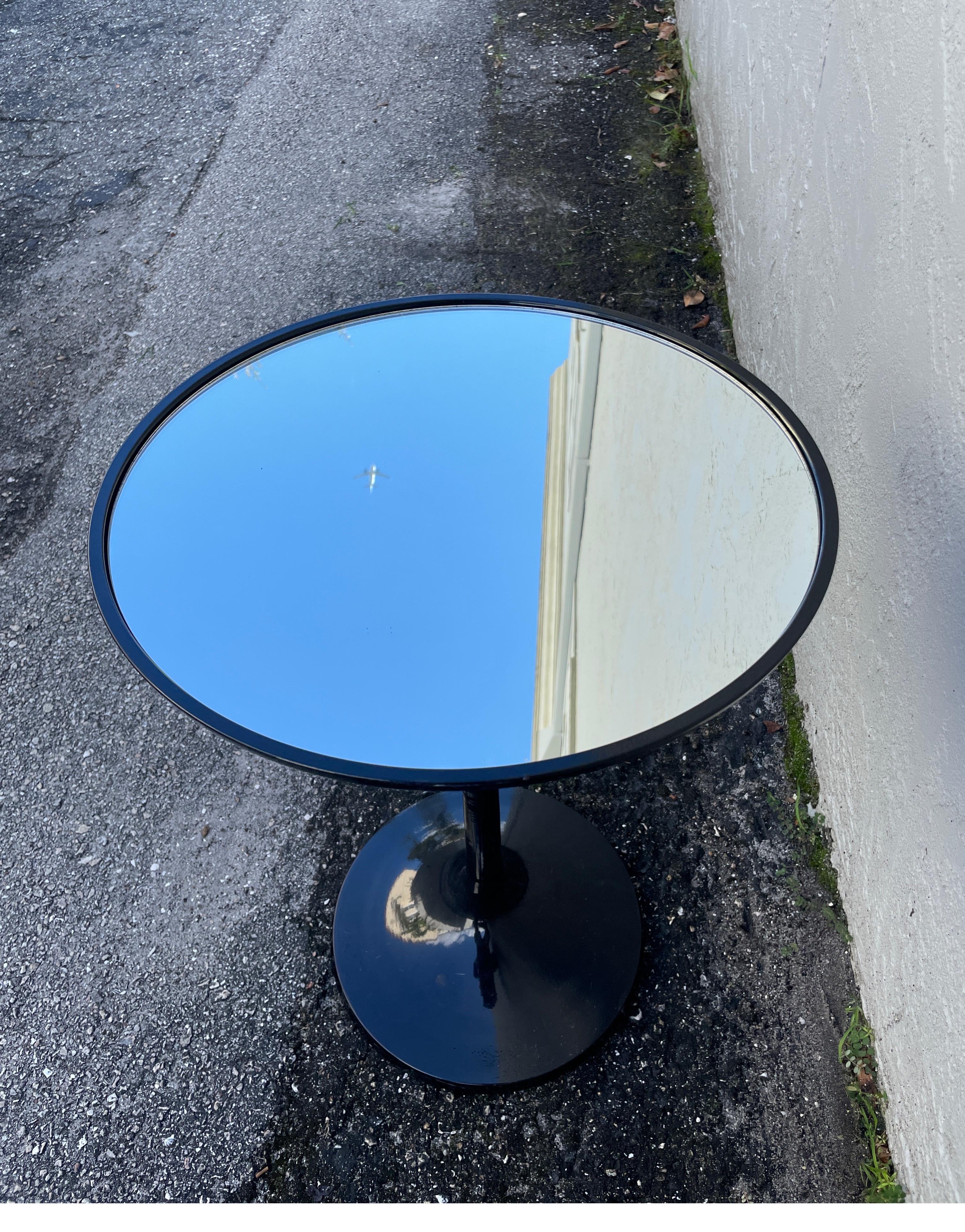Small black lacquered tulip style drinks table with mirrored top.