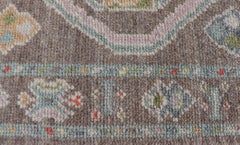 Small Turkish Oushak Rug with Soft Brown Ground and Geometric Pastel Motifs