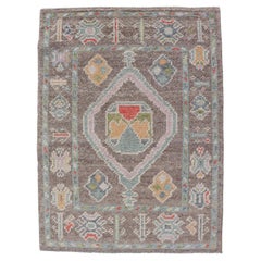 Small Turkish Oushak Rug with Soft Brown Ground and Geometric Pastel Motifs