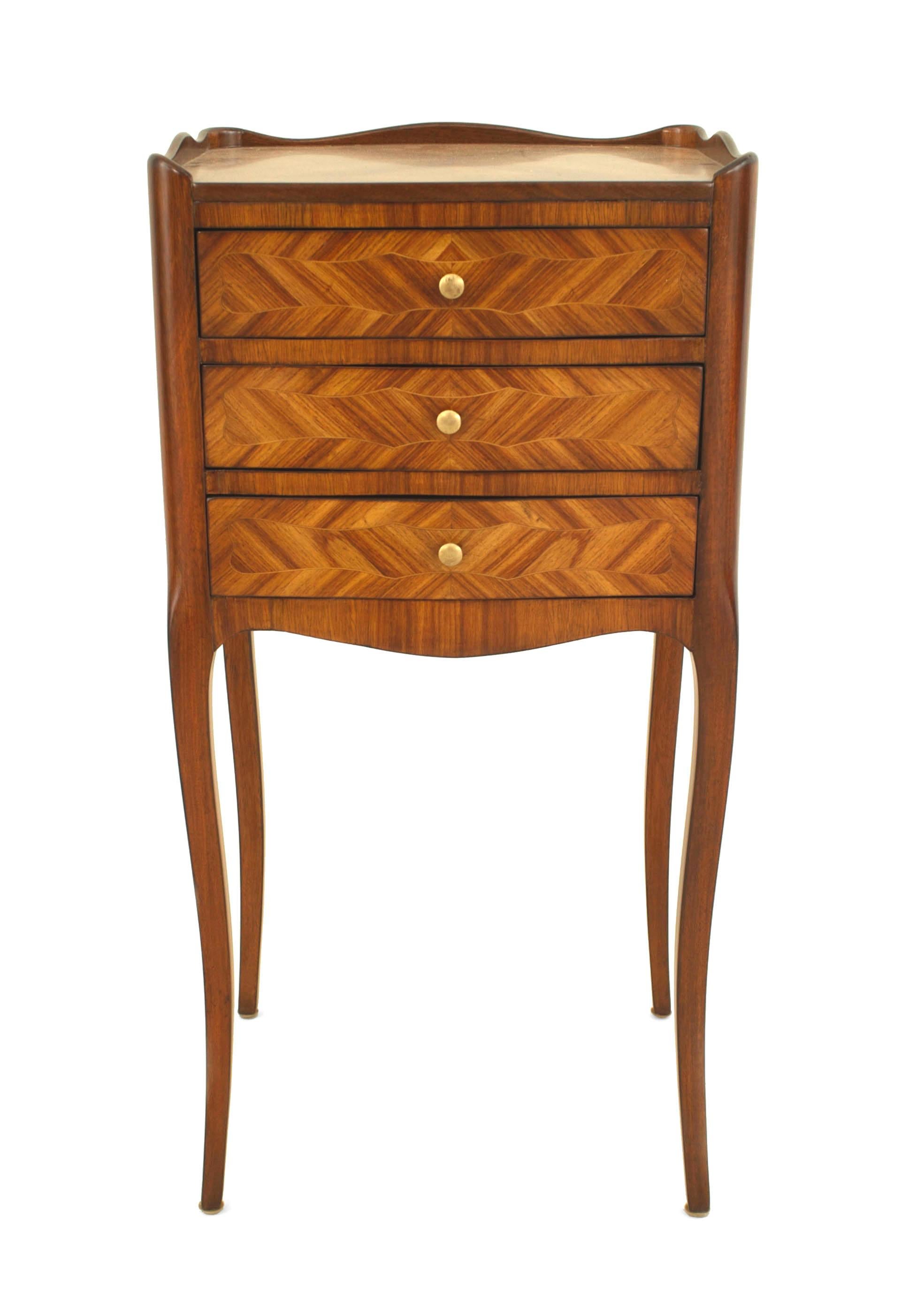 French Louis XV-style (20th Century) tulipwood veneered small bedside table / commode with a gallery and three drawers.
