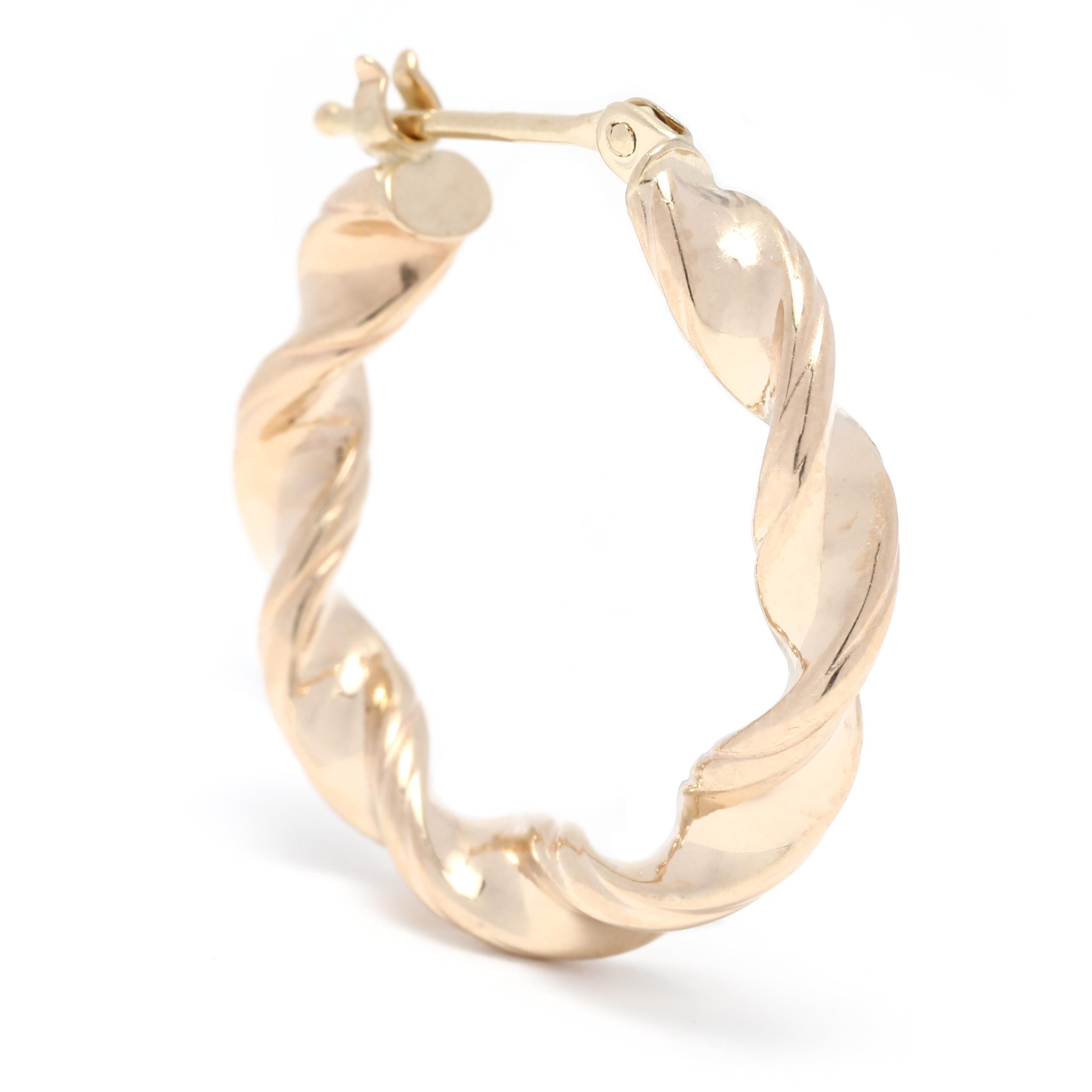 These small twist hoop earrings are the perfect accessory for any occasion. Crafted from 14K yellow gold, they boast a length of 7/8 inch, making them perfect for everyday wear. These small gold hoop earrings have a classic design, with a twisted