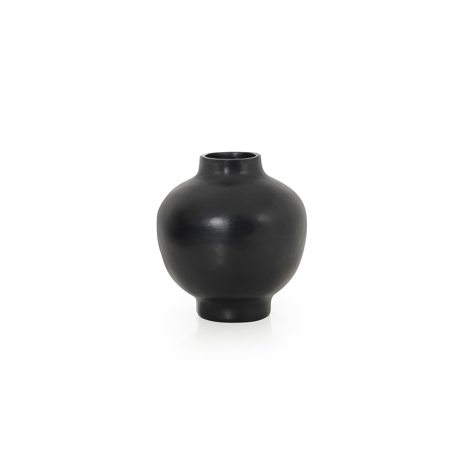 Small vase by Sebastian Herkner
Materials: Heat-resistant black ceramic. 
Technique: Glazed. Oven cooked and polished with semi-precious stones. 
Dimensions: Diameter 23 cm x height 28 cm 
Available in sizes large and mini.

This pot belongs