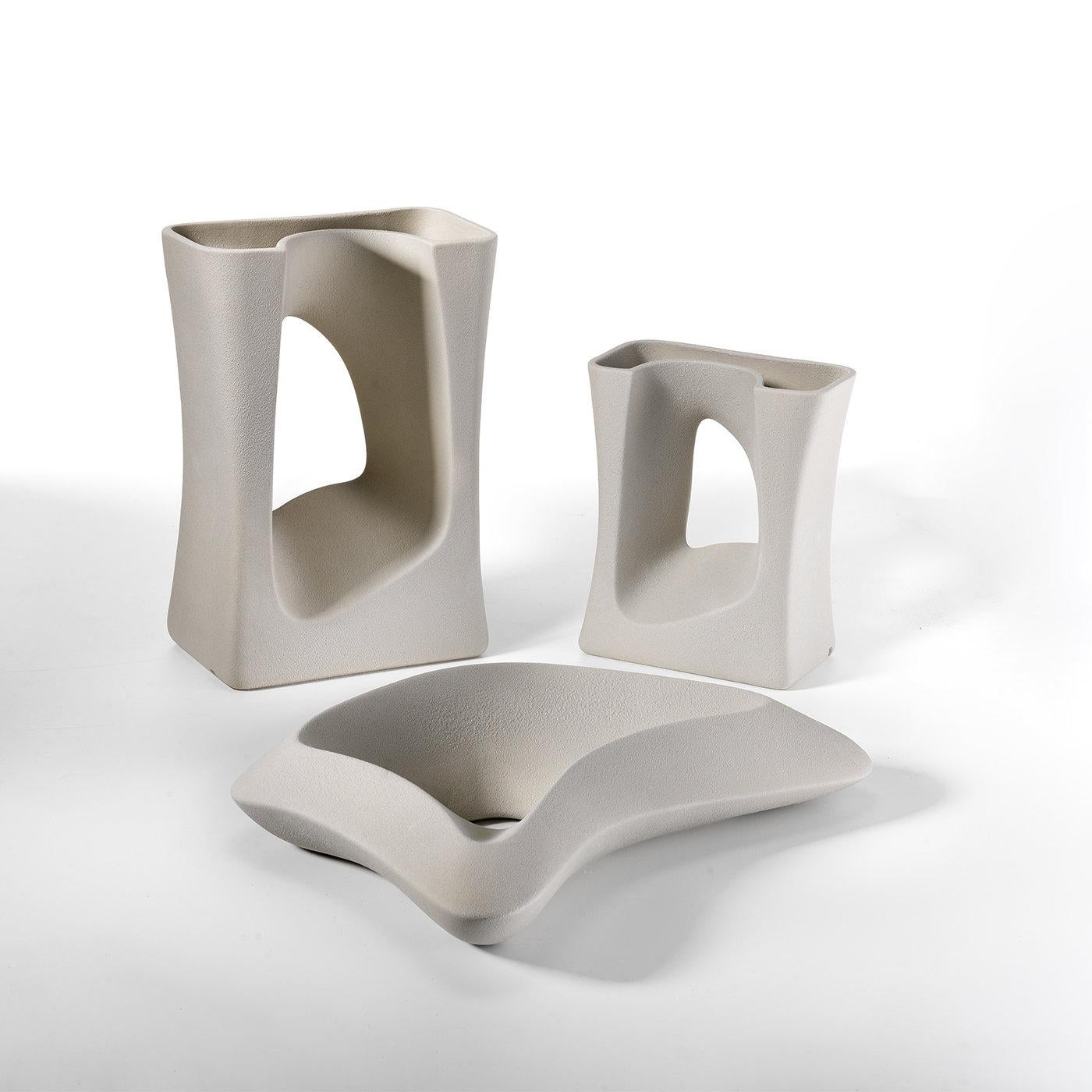 The Small Vase by Tiziano Panigas is characterized by a frame style design providing two sections for the flower stems. Perfect to display in any casual or formal living space, the unique vase is crafted from high quality white ceramic and is