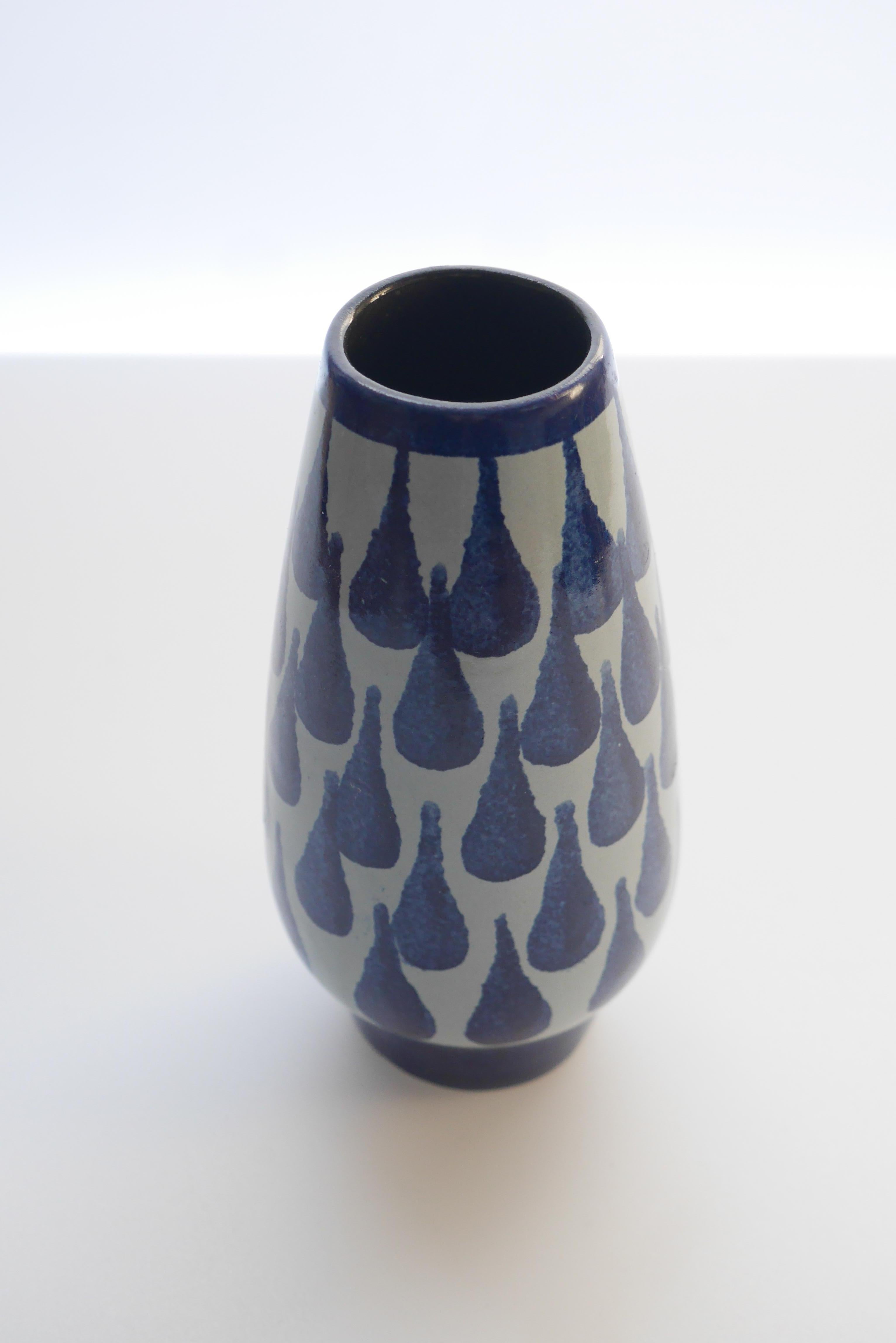 A really sweet, small vase, decorated with a blue drop pattern from Strehla Keramik, Germany, 1960s.

Strehla 1828-1989. 
Originates from Stehla, in Saxony, Germany. After World War II the region became a part of East Germany GDR and the production