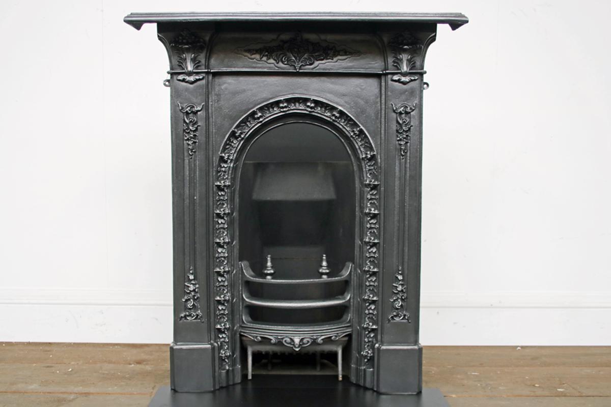 A small Victorian cast iron bedroom combination fireplace with arched aperture and fine detailing throughout.

Finished with traditional black grate polish and supplied with a new clay fireback, cast iron bottom grate and a honed black slate