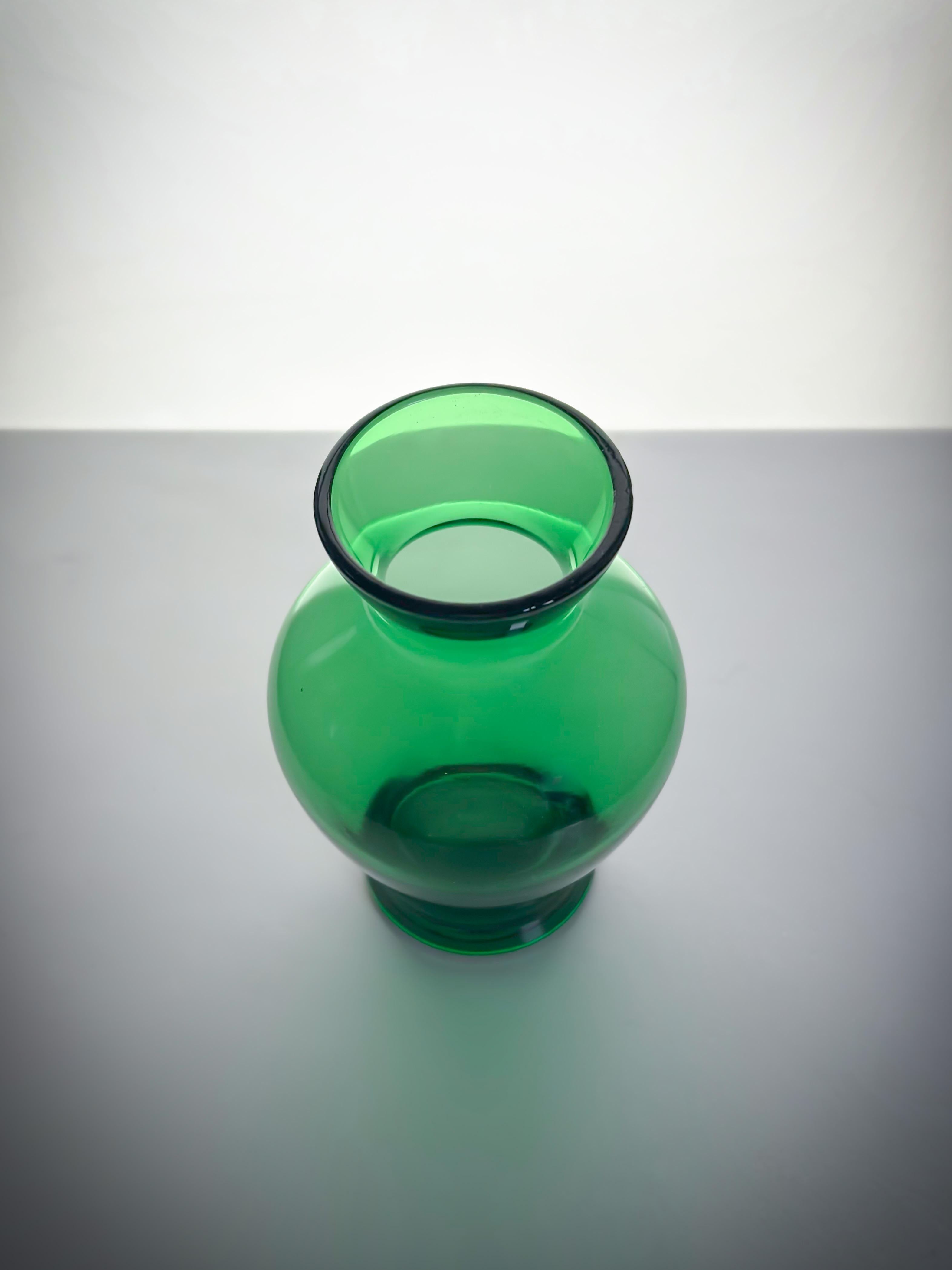 A small late Victorian green glass vase. Crafted in England, circa 1900 

Measuring 11cm tall with a diameter of 7.5cm, this small baluster shaped 1 vase was likely designed as either a bud vase for a small posy of flowers or as a hyacinth vase to