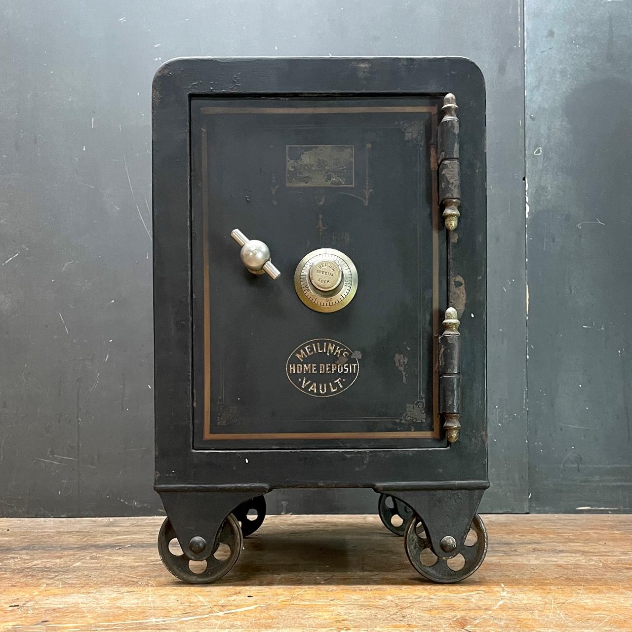 Small/Medium Home Vault or Iron Safe on Railroad (Inline Caster/Wheels.) It rolls smoothly, and has a working locking mechanism and comes with the correct combination to operate.  The safe is empty inside, could also be used as side table to