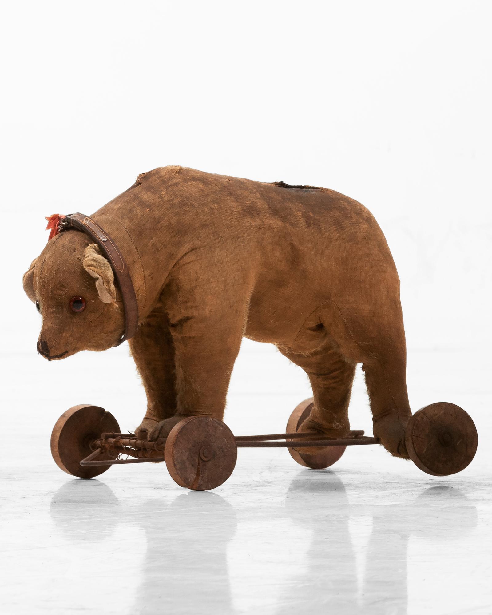 Victorian toy bear pull ride, circa 1900.

Plush toy bear on wheels to be pulled or pushed.

 