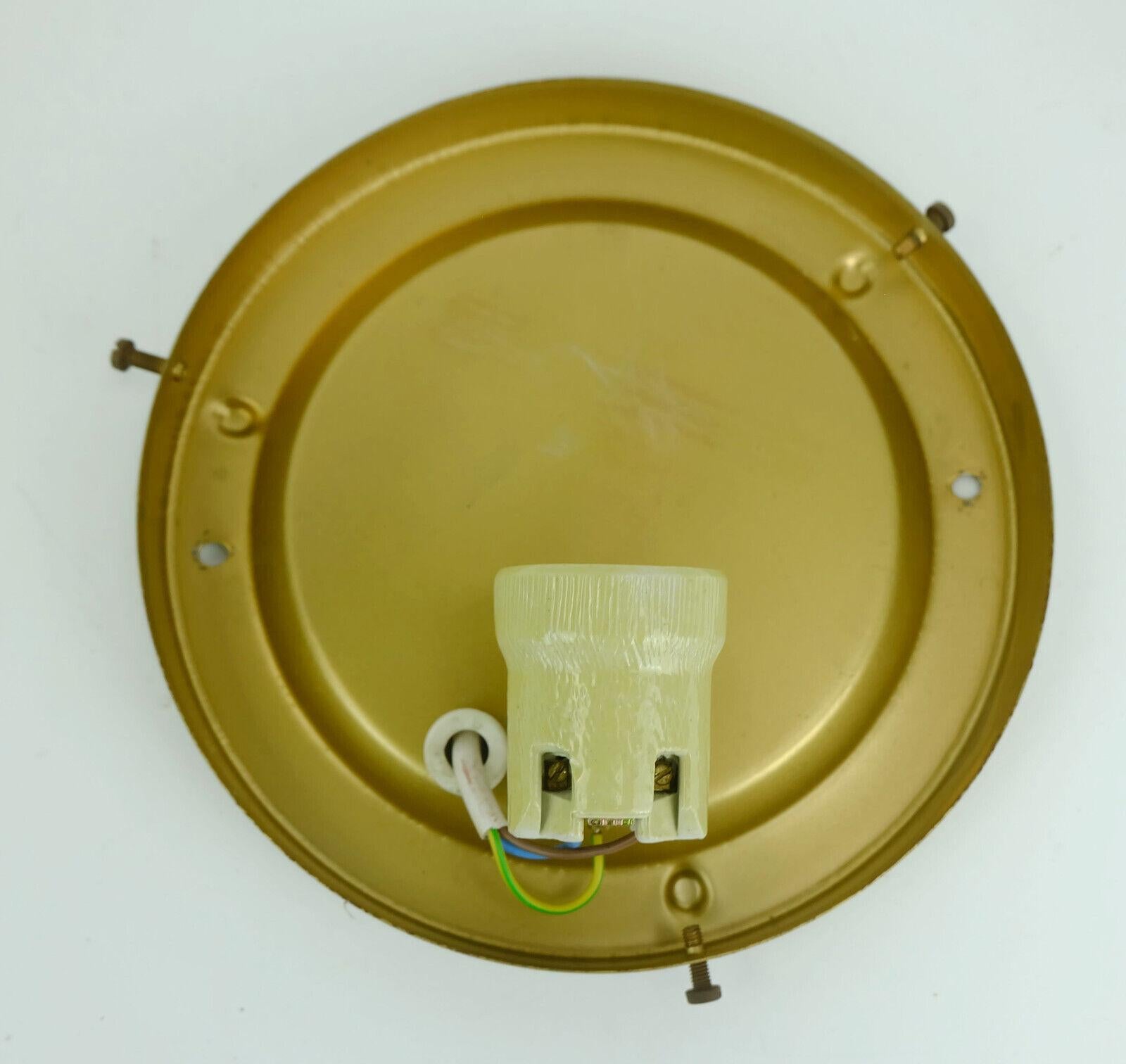 Beautiful sconce or ceiling fixture manufactured in the 1970s by Peill & Putzler. The base is made of gold lacquered metal, the shaped shade is made of etched glass with textured surface and a slight amber color touch. Holds 1 E27 bulb. We recommend