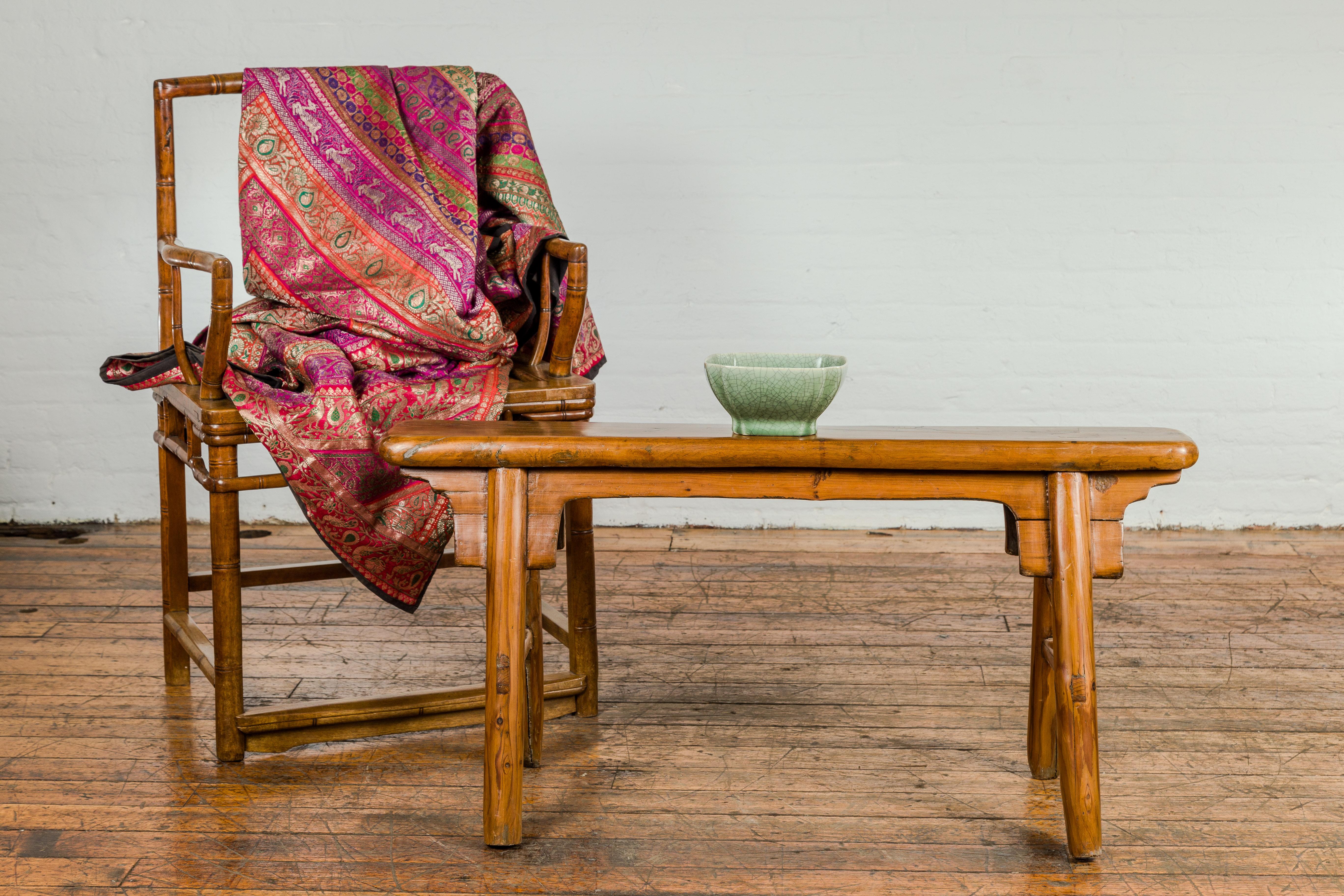 A small vintage A-Frame wooden bench from the mid 20th century with rustic appearance, splaying legs and double side stretchers. Exuding a timeless rustic charm, this small vintage A-Frame wooden bench from the mid 20th century is a delightful