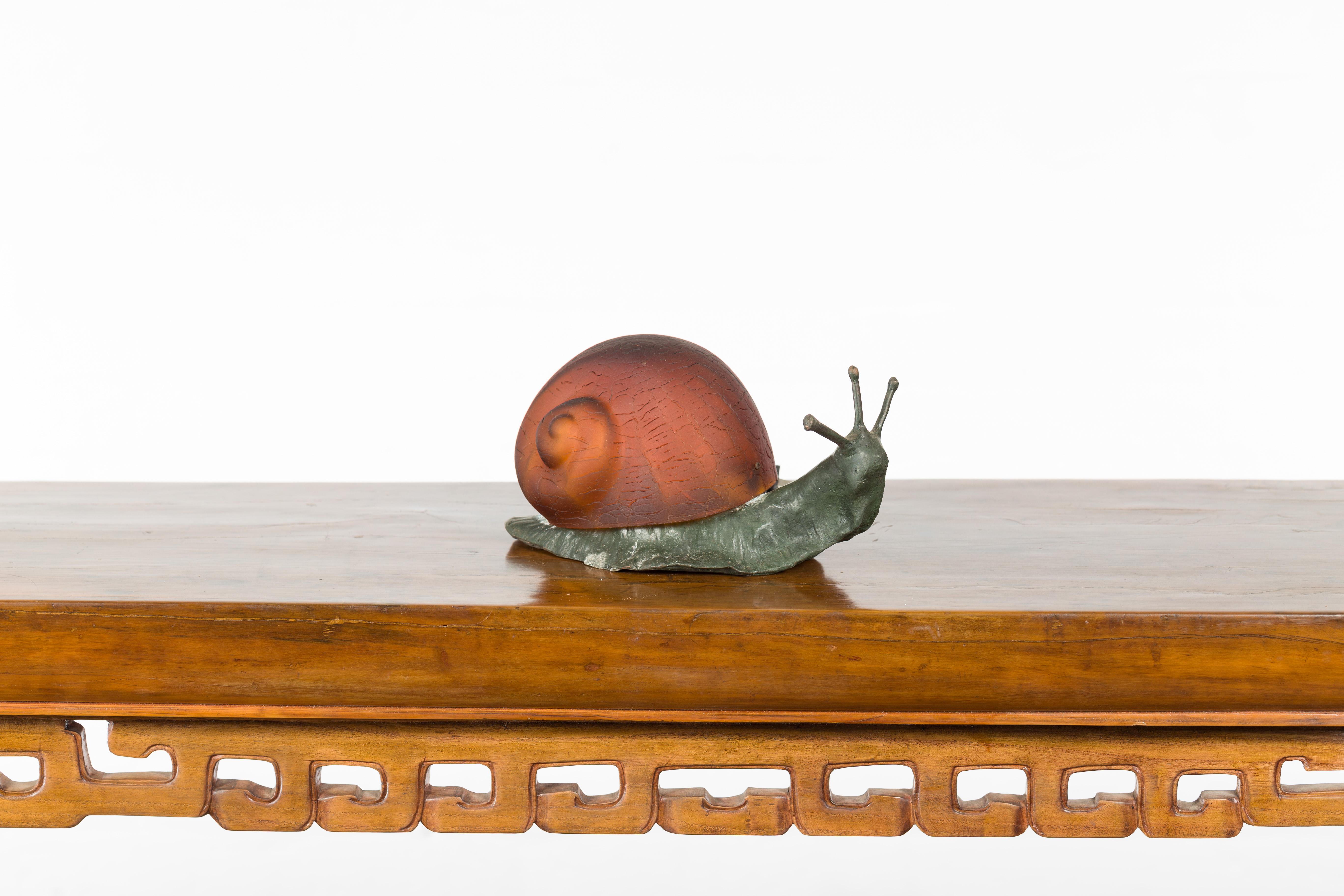 A vintage bronze snail with glass shell body from the mid 20th century, with electrified lamp. We currently have several available, priced and sold $350 each. How not to be charmed by this small bronze 'escargot' turning its head slightly to the