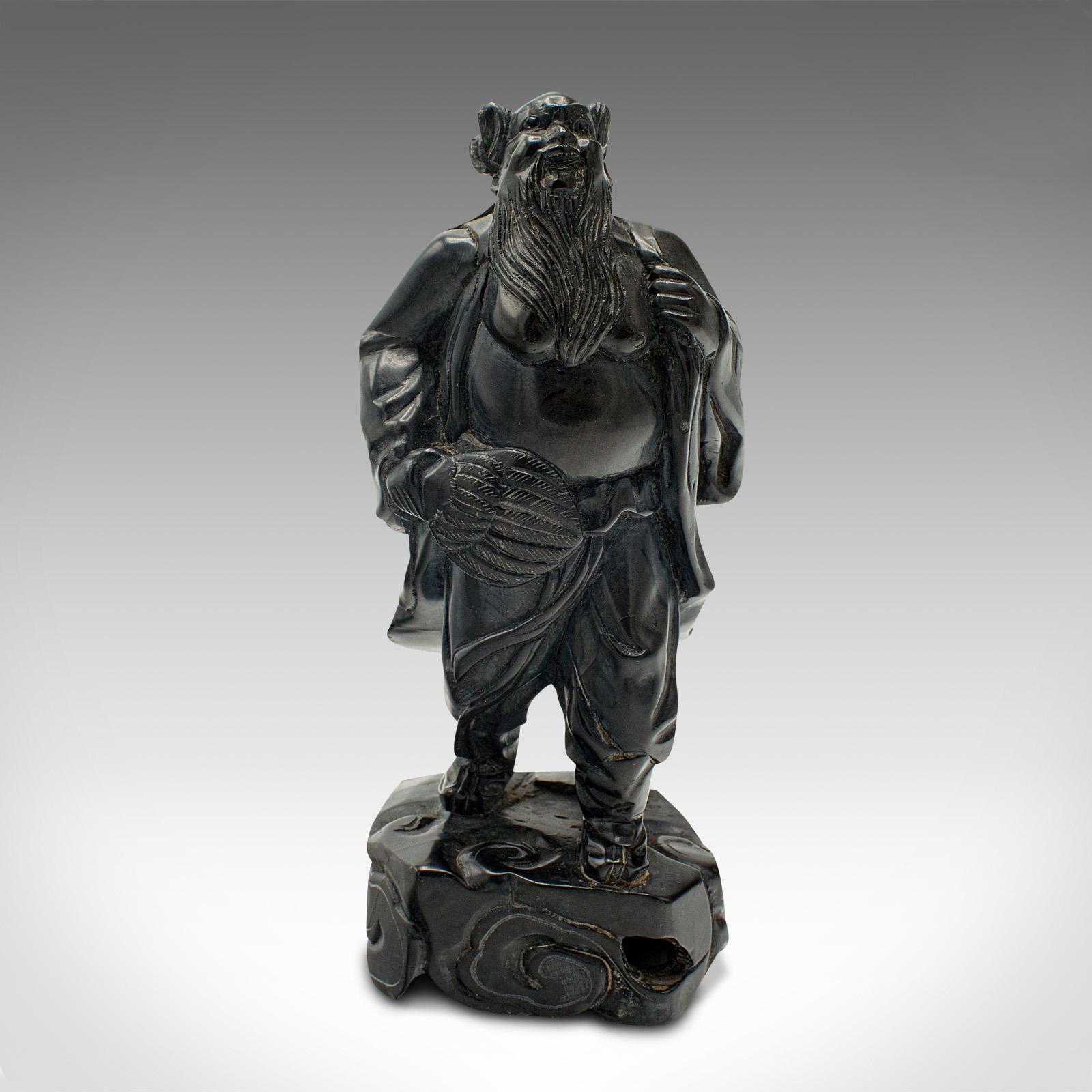 This is a small vintage carved Oriental figure. A Chinese, hand-carved black onyx traditional travelling man statue, dating to the late Art Deco period, circa 1940.

Striking carved figure graced with wonderful craftsmanship
Displays a desirable