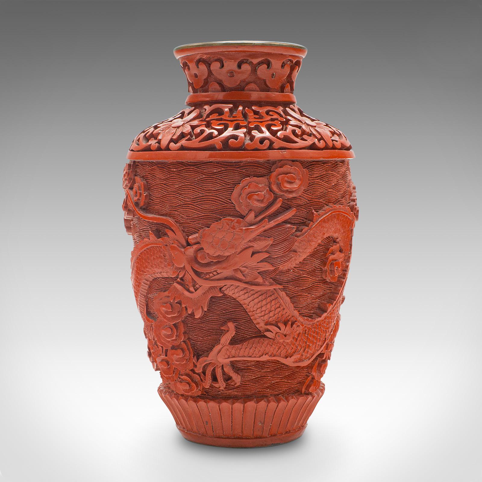 This is a small vintage cinnabar posy vase. A Chinese, carved decorative urn with cloisonné interior, dating to the mid 20th century, circa 1950.

Striking fusion of two traditional Oriental art forms
Displays a desirable aged patina and in good