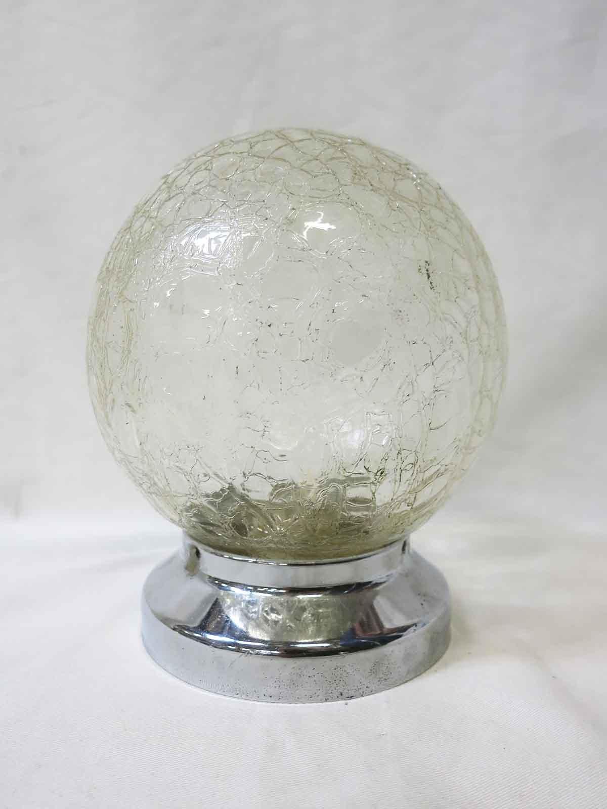 This unique vintage glass globe has a crackled glass textured surface perfect for adding modern charm to any home. Available with a new brass or chrome 3