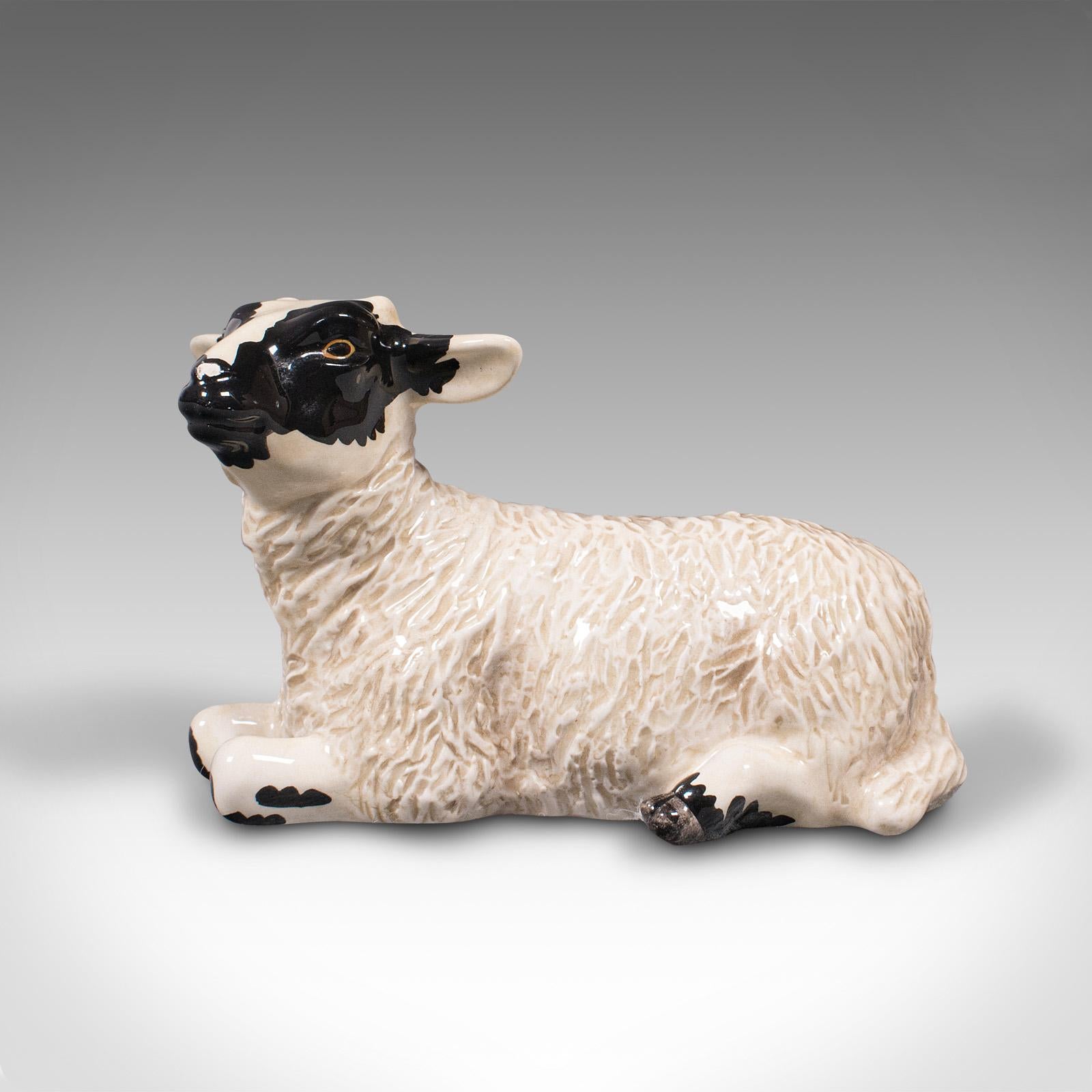 This is a small vintage decorative lamb. An English, ceramic livestock figure by Beswick, dating to the late 20th century, circa 1990.

Delightfully petite with an endearing demeanour
Displays a desirable aged patina and in good order
Pleasingly