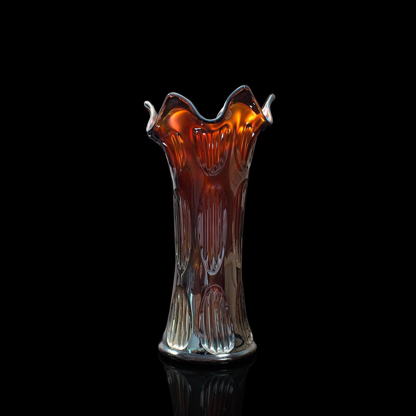 This is a small vintage decorative vase. An English, carnival glass flower vase, dating to the mid 20th century, circa 1940.

Fiery red hues beneath the distinctive lustre
Displays a desirable aged patina and in very good order
Expressive fluted