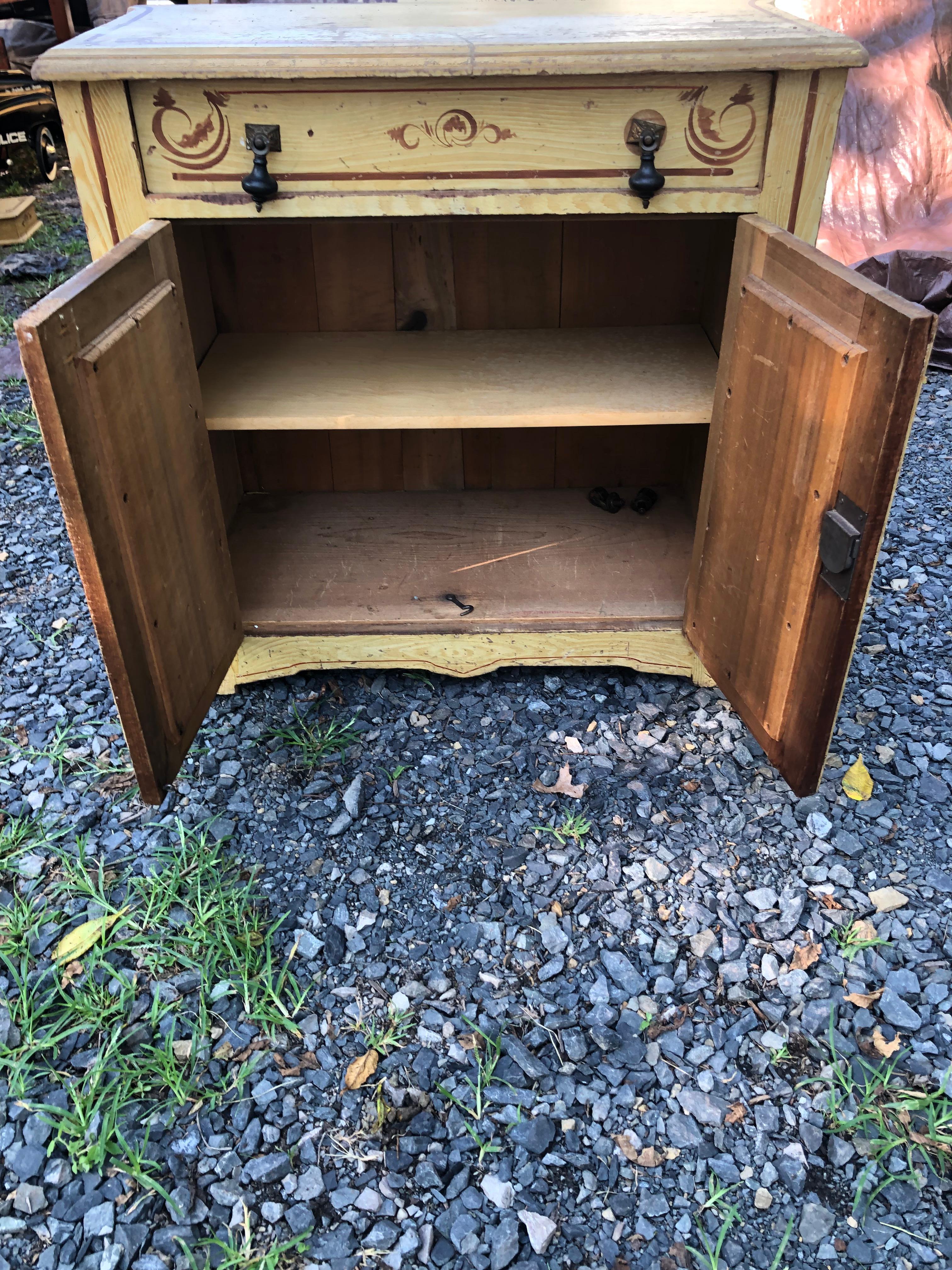 Versatile small to medium sized hand painted rustic cabinet from Pennsylvania Amish country having single drawer and two doors that open to storage inside.  Left in distressed condition.
Many other matching pieces are listed including large dresser