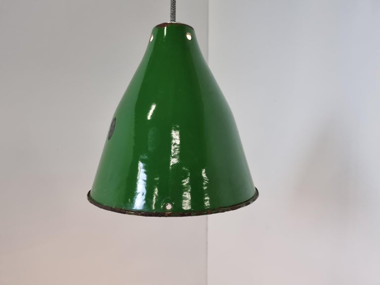 Vintage industrial pendant lights in green enamel.

The lamps emit a soft light thanks to the white enamelled finish on the inside.

The lamps where salvaged in Hungary and have a beautiful patina

Fully rewired and tested 

E27 light socket

1960s