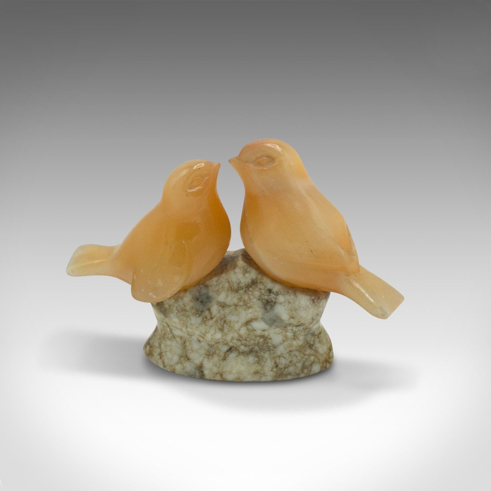 This is a small vintage lovebird ornament. A Japanese, yellow onyx and granite decorative figure, dating to the late Art Deco period, circa 1940.

Delightfully sweet decorative item, a treat for lovers or collectors.
Displaying a desirable aged