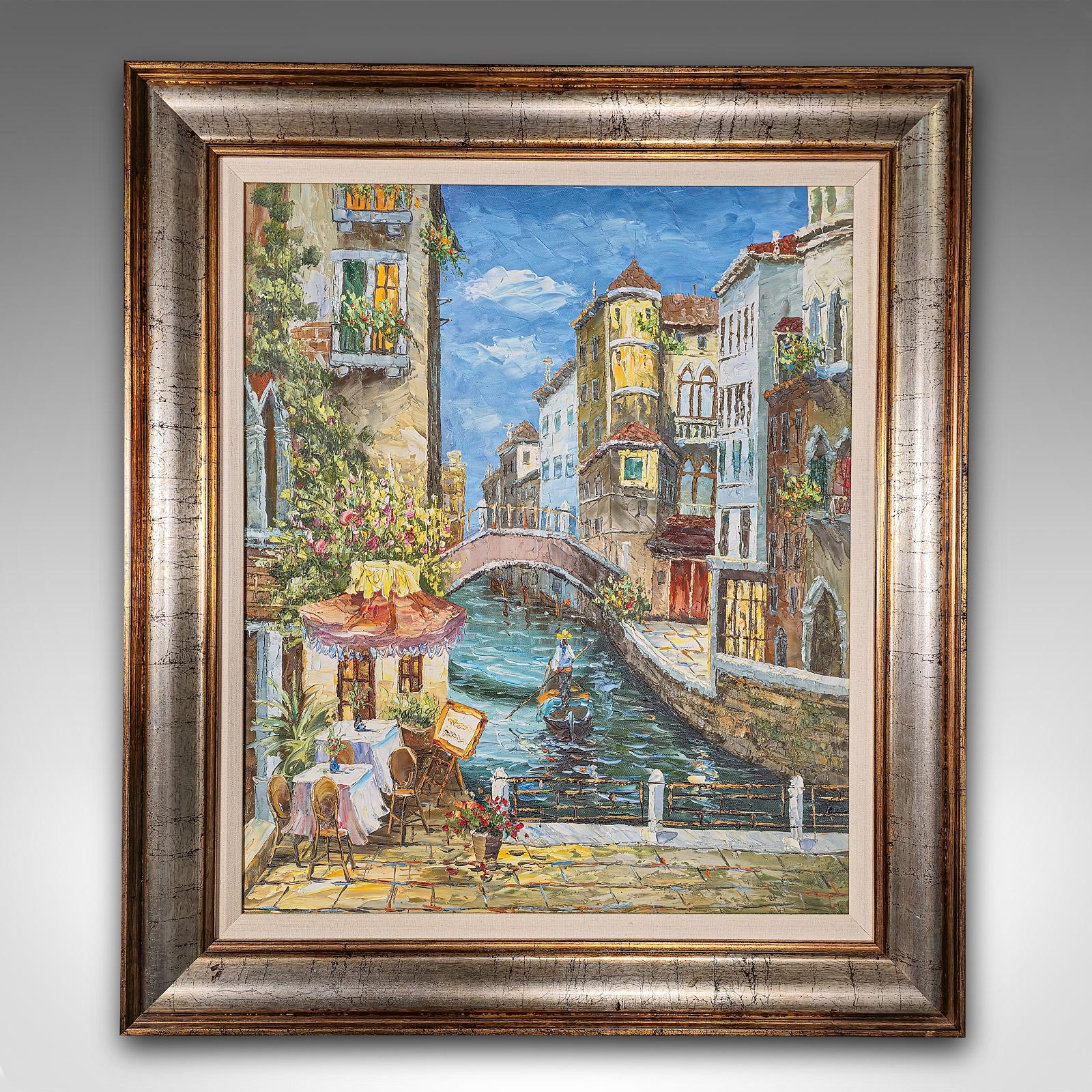 This is a small vintage oil on canvas of Venice. An unsigned Venetian street scene in quality frame, dating to the late 20th century.

Inviting Venetian scene of a small cafe next to a canal
Presented in a quality later frame with broad, rolled form