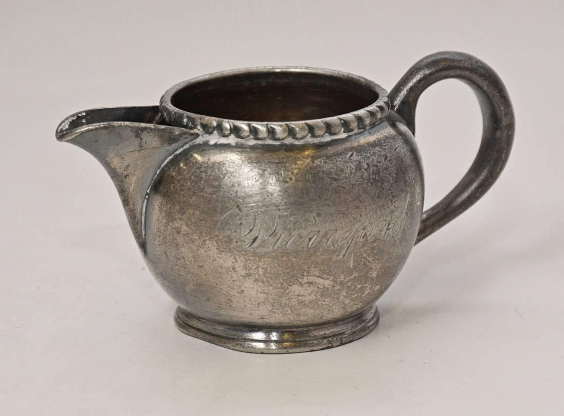 The very petite vintage pewter creamer, while small but full of charm, has a beaded rim and is stamped on the side Pierrepont and on the bottom made and guaranteed by Meriden Company USA, 908 1/4 pt.