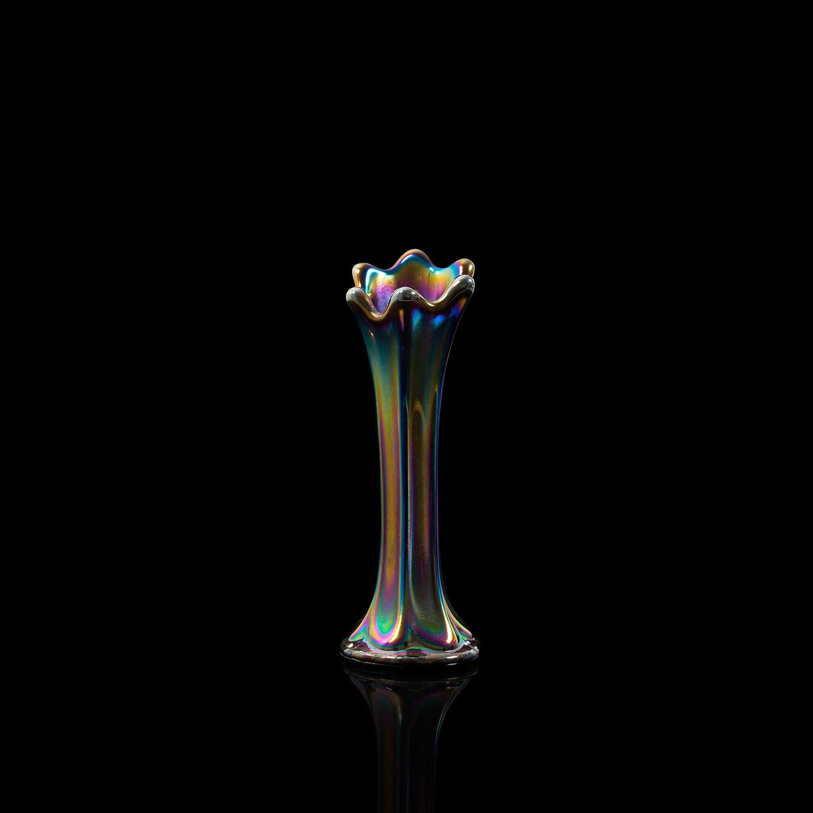 This is a small vintage posy vase. An English, carnival glass decorative flower vase, dating to the mid-20th century, circa 1950.

Dashing iridescent spectrum
Displaying a desirable aged patina
Colorful glass in very good order, free of cracks