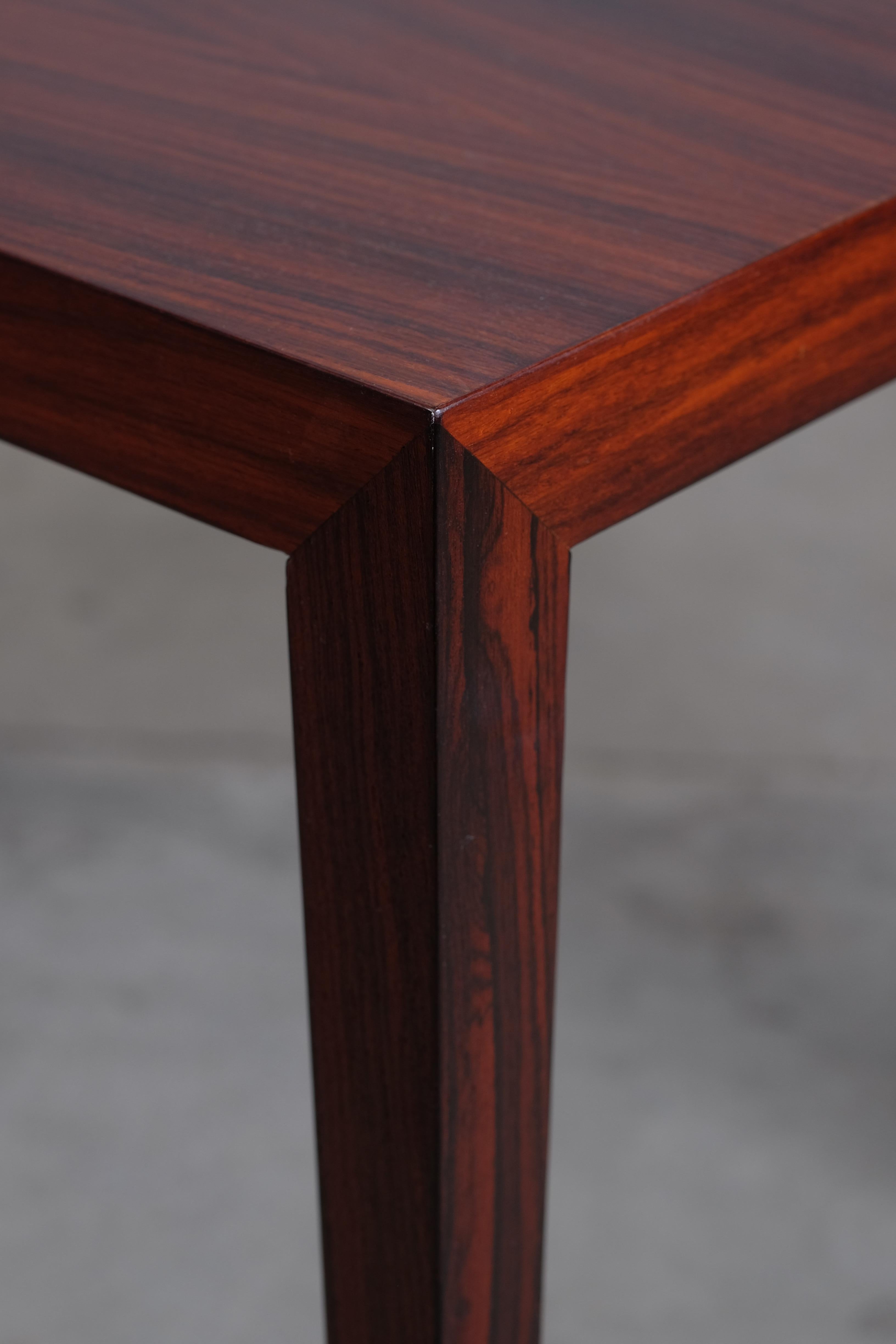 Beautiful small rosewood coffee table designed by Severin Hansen. Produced by Haslev Møbelfabrik around the 1960s. The table are very light and elegant with the tall tapering legs which join the top with a signature triangle join between the leg and