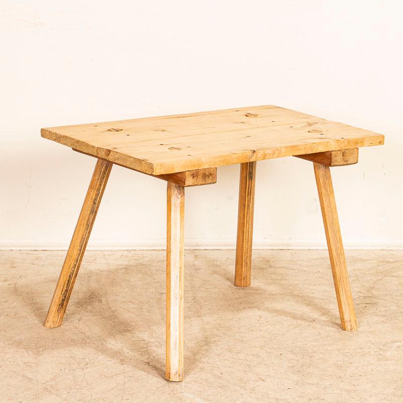 This rustic table with peg legs will serve well as a small coffee table or unique side table. It is restored so it is strong/stable and has a clear wax finish.