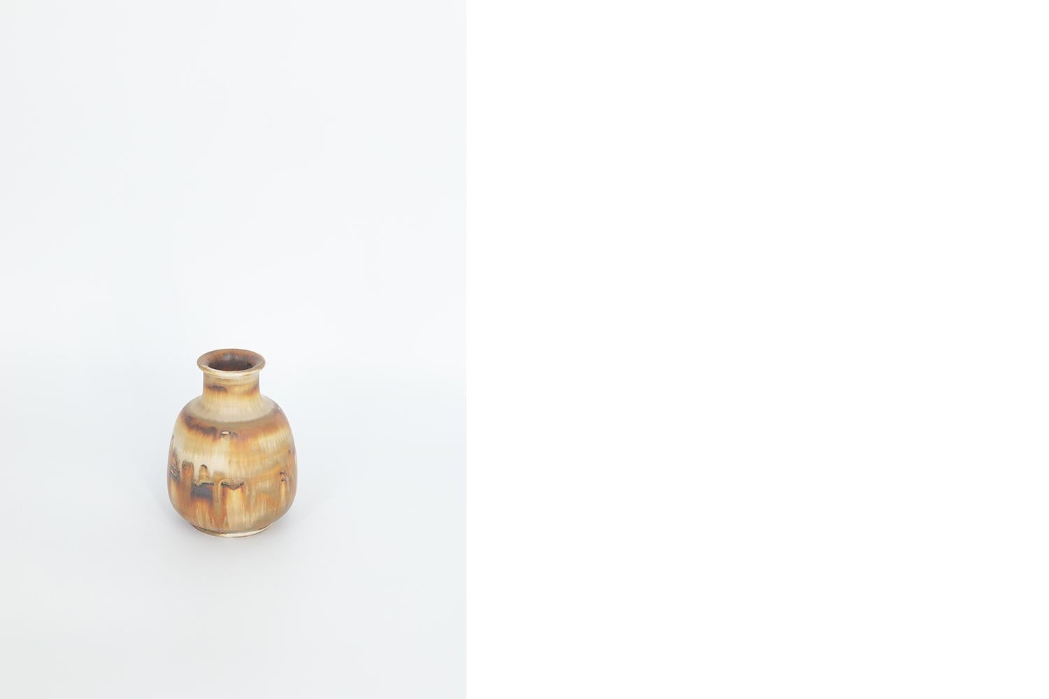 This miniature, collectible stoneware vase was designed by Gunnar Borg for the Swedish manufacture Höganäs Keramik during the 1960s. Handmade by a Master, with the utmost care and attention to details. The vase dyed brown in an irregular shade.