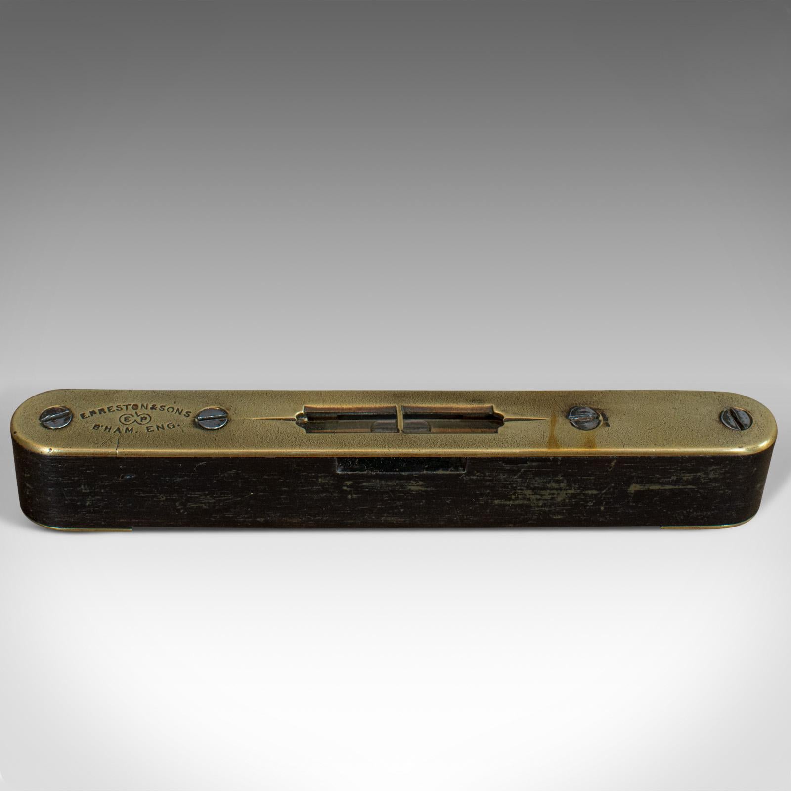 This is a small vintage spirit level. An English, rosewood and brass instrument by E. Preston and Sons, dating to the early 20th century, circa 1930.

Pleasingly diminutive spirit level
Displays a desirable aged patina
Brass top plate and end