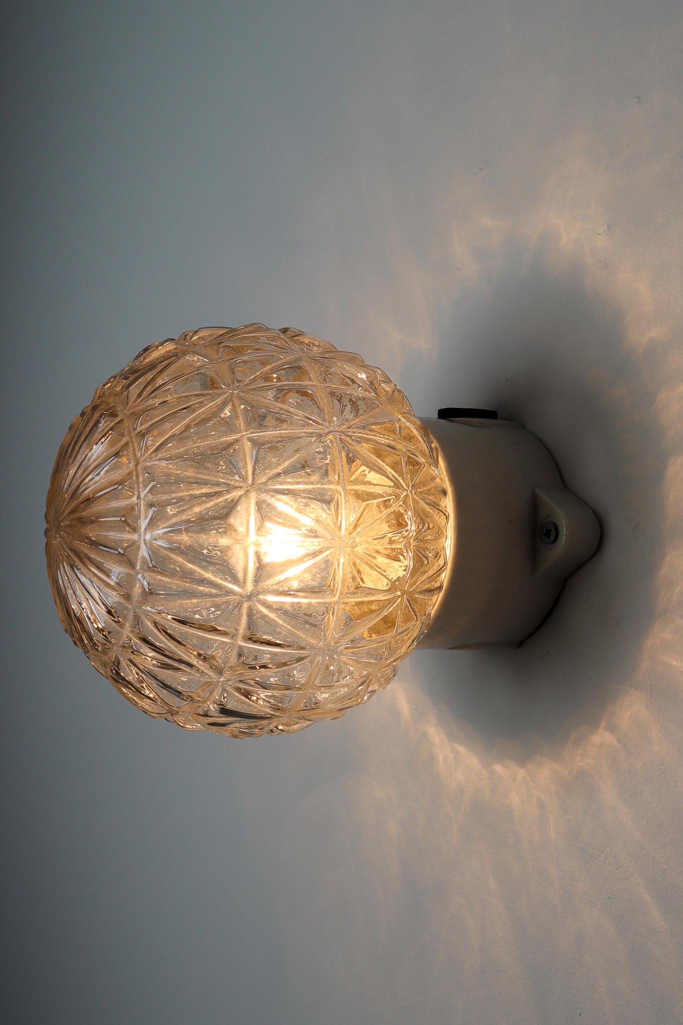 Small vintage modern wall/ceiling lights with clear structured glass and porcelain base , France 1960s. The glass has pattern in it, what gives a nice diffuse light effect and a nice pattern on ceiling and walls, these wall scones/ceiling lights