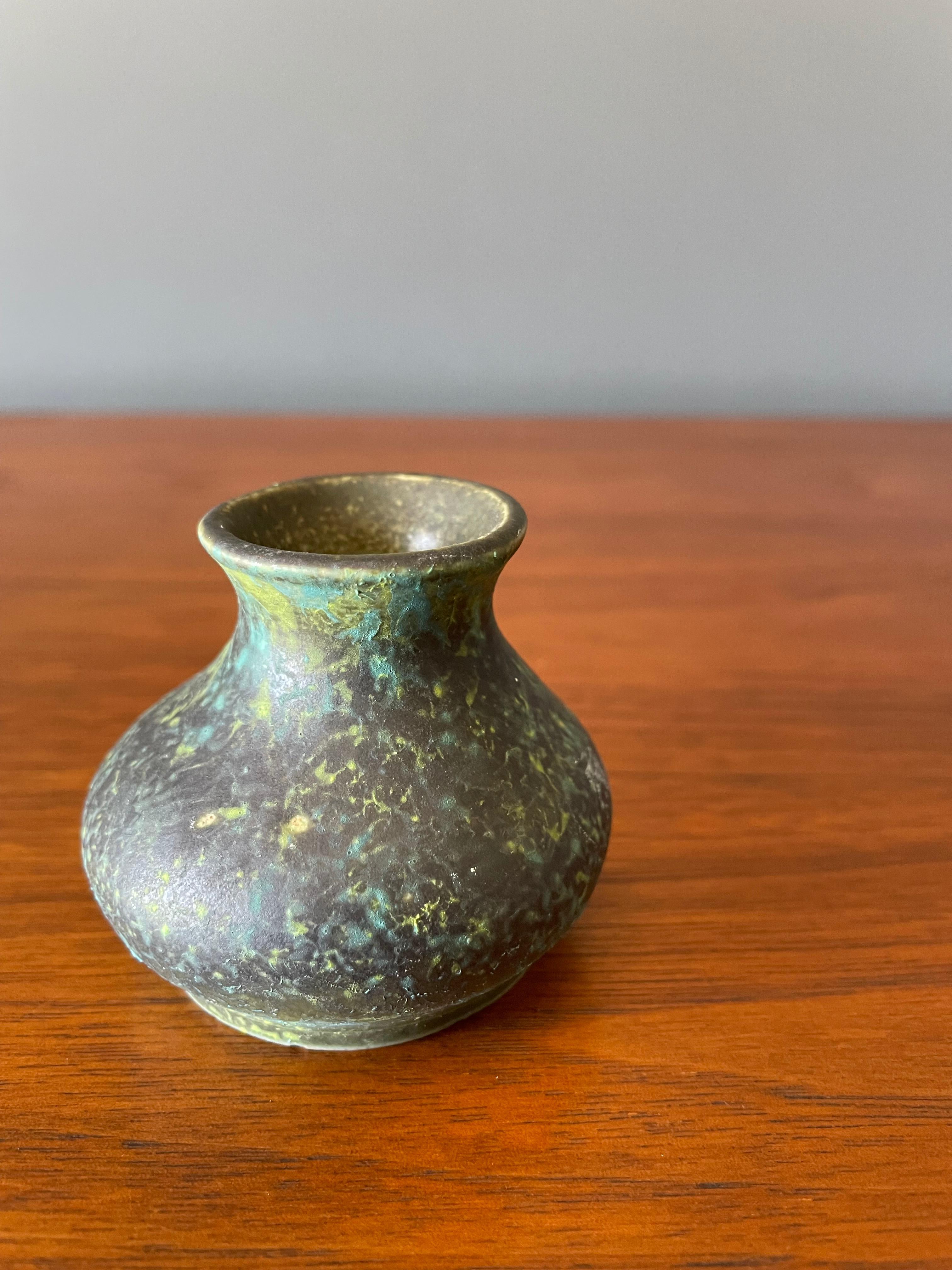 Vintage bud vase. Extra small in stature. Finished in a matte green speckled glaze.
