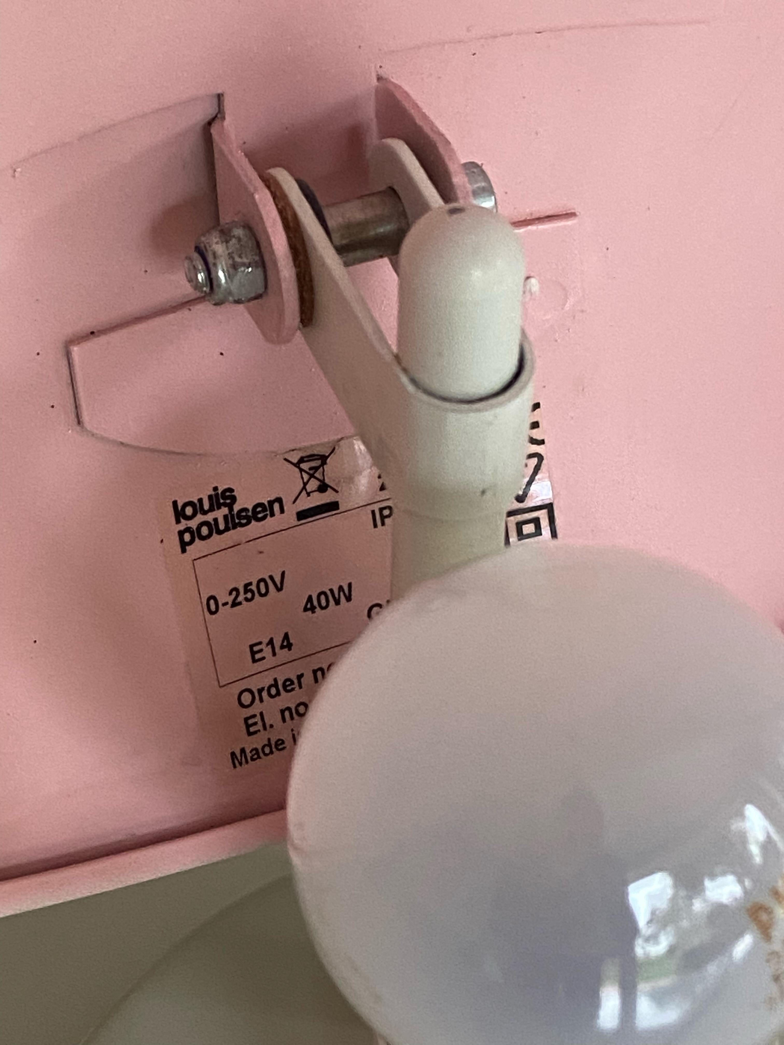 PH hat wall lamp in white with pink designed by Poul Henningsen small Version manufactured by Louis Poulsen in Denmark. Labeled with sticker from Louis Poulsen. 
Measure: Diamter 22cm. The wall lamp come with an E14 Edision screw socket and switch