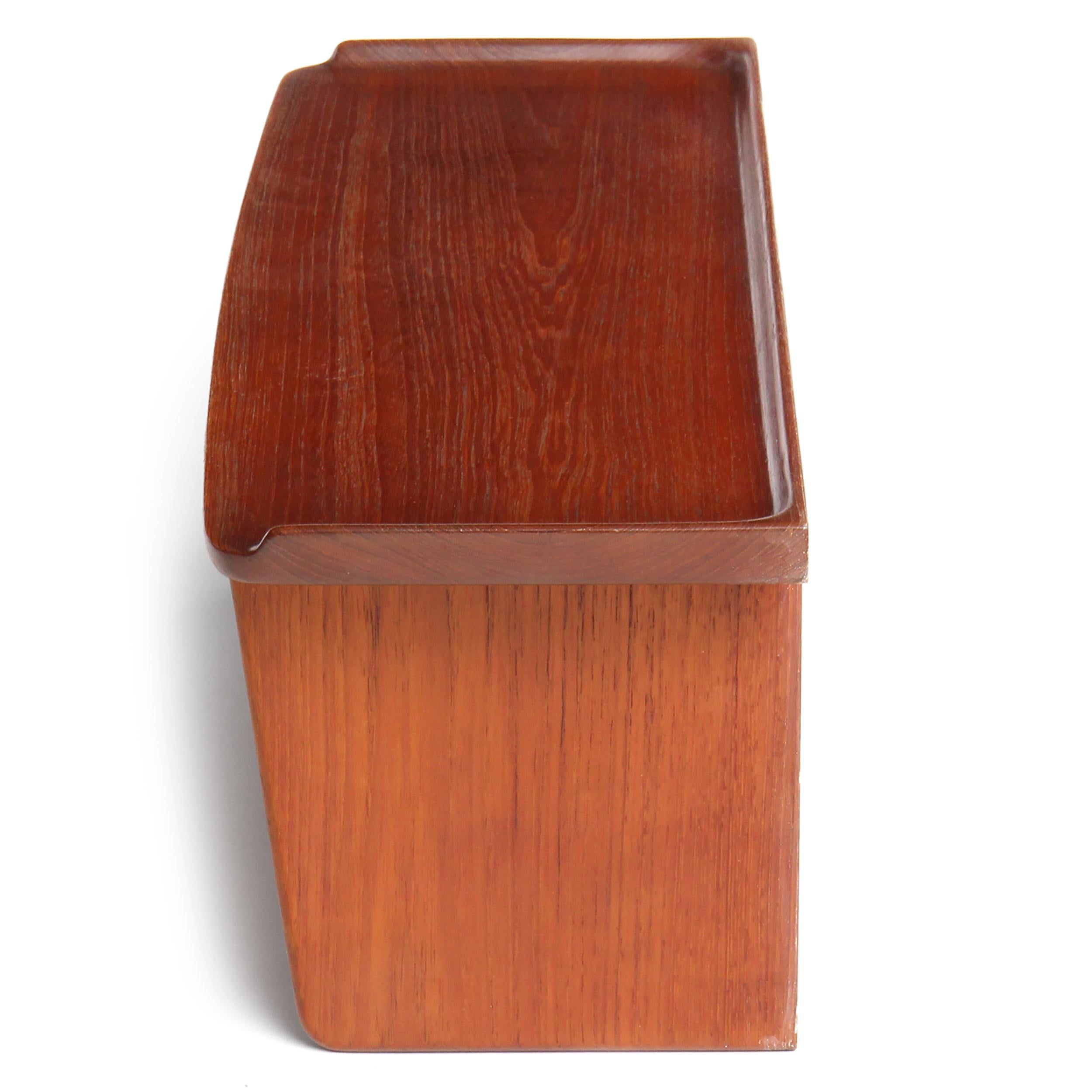 A solid teak wall-mount box with a gallery top and a flip-down storage bin.