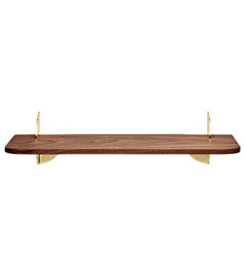 Small walnut and steel minimalist shelf 
Dimensions: L 50 x W 18 x H 12 cm 
Materials: Steel W. Powder Coating, Brass Plating & Walnut MDF.
Also available in Black Ash and in size Large.

Simplicity always seems to make the most sense. The new
